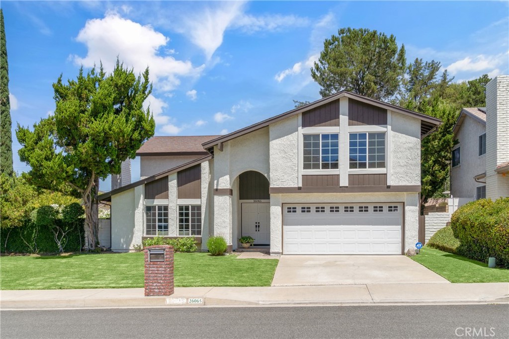 Nestled in the peaceful Malibu Canyon enclave of Calabasas, this beautifully maintained residence combines spacious living with timeless design and a true sense of community. Set on a quiet street celebrated for its neighborhood charm and legendary Halloween festivities, the home offers 2,562 sq ft of thoughtfully designed living space with 4 bedrooms and 3 full bathrooms. A double-door entry opens to an inviting living room with fireplace and formal dining area, while soaring beamed ceilings, recessed lighting, and abundant natural light create an open, airy feel throughout. At the rear of the home, a comfortable great room overlooks the picturesque backyard with pool and spa, seamlessly connecting indoor and outdoor living. The chef’s kitchen showcases rich wood cabinetry, granite countertops, and high-end stainless-steel appliances, perfect for both casual meals and entertaining. The main level also features a private bedroom with adjacent full bath, plus a laundry room with direct access to the attached 2-car garage. Upstairs, the primary suite impresses with vaulted ceilings, dual closets, and a serene ensuite bath with dual vanities, joined by two additional spacious bedrooms, a full bathroom, and an oversized bonus room ideal for a game room, home office, or gym. Outdoors, a private retreat awaits with a sparkling pool and spa, built-in BBQ, and a wraparound brick patio framed by mature landscaping and tranquil hillside views. Just minutes from Gates Canyon Park, Erewhon Market, and premier shopping and dining in Calabasas, with access to the award-winning Las Virgenes Unified School District, this property blends comfort, convenience, and natural beauty—an exceptional opportunity to enjoy the coveted Calabasas lifestyle.