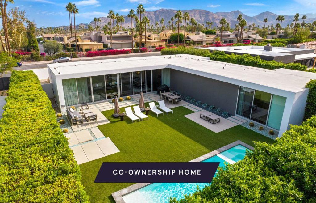 New co-ownership opportunity: Own one-eighth of this professionally managed, turnkey home. This 3-bedroom, 3.5-bathroom home is a stunning example of desert modern design, where clean lines, natural materials, and expansive glass create a seamless connection between indoor and outdoor spaces. Thoughtfully designed, the L-shaped layout maximizes privacy while capturing breathtaking mountain views through floor-to-ceiling glass walls. Warm wood-clad ceilings and floors add texture and warmth to the open living space, where a sleek, integrated kitchen blends effortlessly into the design. A recessed stainless steel refrigerator, gas range, and discreet vent hood maintain the home's streamlined aesthetic, while rich wood cabinetry and an extended countertop provide both style and functionality. Each of the three bedrooms includes an en-suite bathroom and private patio, offering comfort and retreat-like privacy. The spa-like primary bath features an oval soaking tub, a dual-sink vanity, and a direct connection to the outdoor living areas. Designed for effortless outdoor living, the landscaped yard includes a vibrant artificial turf lawn, broad pavers, architectural stone accents, a glass fire pit, and a pool with fountain and spa. Thoughtful design and high-quality materials create a low-maintenance yet striking outdoor space. The homes comes fully furnished and professionally decorated.