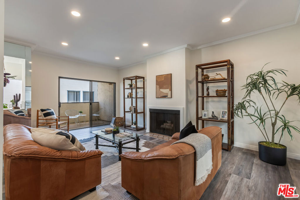 This move-in ready 2 bedroom, 2 bathroom condo (1,235 sq ft) is tucked right in the heart of Glendale. Inside, you'll find a welcoming living room with a cozy fireplace and a sunny kitchen with freshly painted cabinets. Both the living room and kitchen connect to a private balcony, giving you a nice indoor-outdoor feel. The primary suite has its own on suite bathroom and both bedrooms have balcony access.This stylish unit features newer laminate floors and updated appliances, offering a fresh, modern touch throughout. The in-unit washer/dryer makes laundry days way easier and central AC keeps things comfortable all year long. The building offers secure underground parking with two side-by-side spots and elevator access.You'll love the locationjust a few blocks off Brand Blvd and minutes from Porto's, Whole Foods, The Americana, the Galleria, restaurants, and theaters. It's truly a walker's paradise.Whether you're a first-time buyer or just looking to be in a prime Glendale spot, this condo checks all the boxes.