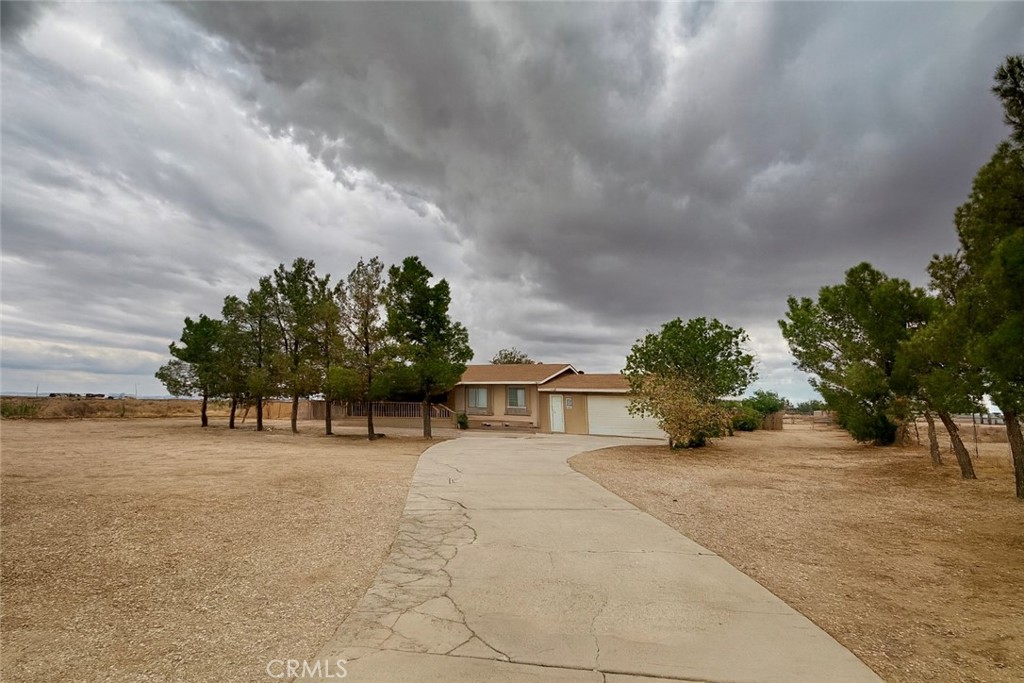 The perfect blend of space, comfort, and country living at this fully fenced and gated 2.5-acre ranch retreat with endless possibilities. This home features 4 bedrooms, 2 full bathrooms, a spacious master suite, an open kitchen, and both a living room and a family room designed for gatherings. Enjoy beautiful fruit and shade trees, a private backyard ideal for entertaining, plus facilities for horses and poultry with plenty of storage. The property also boasts its own private well, a 2-car attached garage, carport, and two RV hookups, offering everything you need for true country living just minutes from town. Don’t miss this opportunity to make this your dream playground. Schedule a private tour today and see all it has to offer! The seller may also finance a 5-acre lot located directly behind the property, which is available for purchase. Both lots would make the entire property 7 acres. APN 375-061-08-00-2 asking $190,000 for the adjacent 5-acre lot.