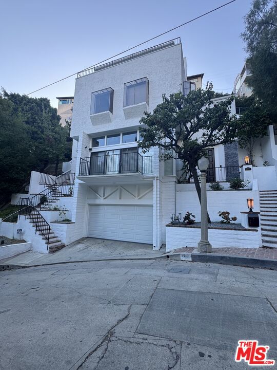 Located in the heart of the Hollywood Hills, this 3 bedroom, 3.5 bathroom home spans three levels of thoughtfully designed living space. The living room exudes glamour and allure with its beautiful high ceilings, striking fireplace, and sliding glass doors that lead to the front balcony. Enjoy the hillside air and scenic surroundings with great views of the city. Spacious kitchen, paired with a large dining area with French doors, is perfect for hosting intimate gatherings or casual meals. 2 large suites serve as the bedrooms on the second floor, complete with walk-in closets and extra room ideal to create an office, play area or even another bedroom, offering both comfort and functionality. On the top floor, a bright and light filled bedroom with a snug fireplace opens to a private balcony through sliding glass doors, with spectacular views of the city and the canyon. Beautifully large bathrooms throughout. The home also features a rear patio area, ideal for outdoor entertaining or children's play. Attached direct access 2-car garage. Conveniently located within a minute's drive to trendy shopping, dining, and entertainment options along the iconic Sunset Strip. This Hollywood Hills gem is ready for you. Schedule a private showing today and experience the magic for yourself!