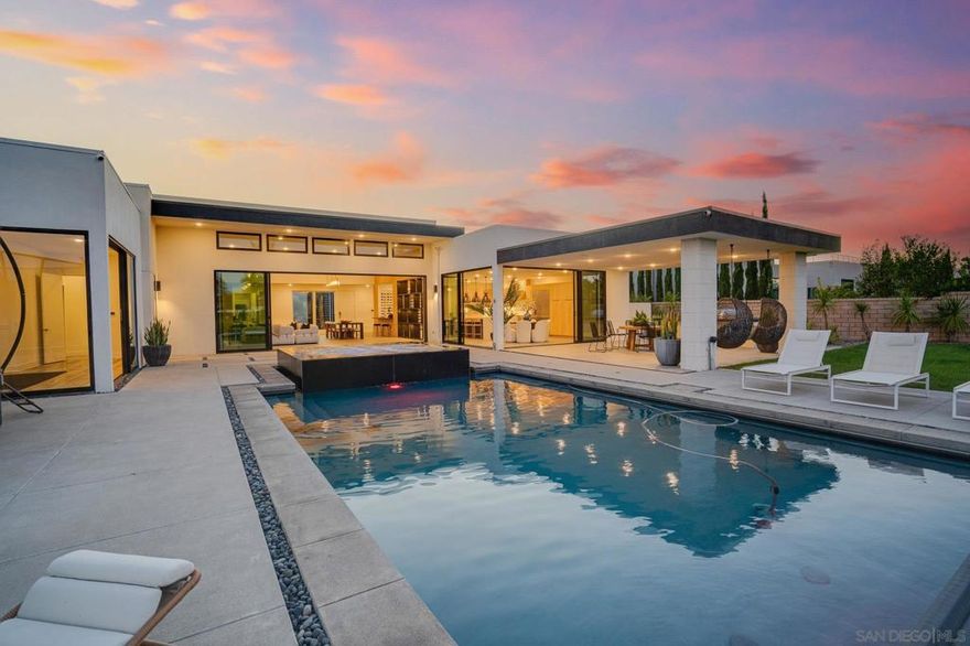 Luxury single-story smart home in the gated Aurora Summit Trails community. Soaring ceilings, abundant natural light, and seamless indoor-outdoor flow define this elegant residence. Features include custom glass-backed built-ins, a sleek bar with wine-wall display, and a chef’s kitchen with oversized island and top-of-the-line appliances.  The primary suite offers floor-to-ceiling glass doors, spa-inspired ensuite, and custom walk-in closet. An attached casita is perfect for multigenerational living or can be used as a playroom or home theater.  Step outside to a resort-style backyard with pool, oversized spa, outdoor kitchen and bar, and lush green play area. Additional highlights include owned solar, zoned HVAC, and spacious secondary bedrooms.  Residents enjoy community pools, spas, fitness centers, event lounges, and scenic parks and trails. Located in an award-winning school district near premier shopping, dining, and the coast.