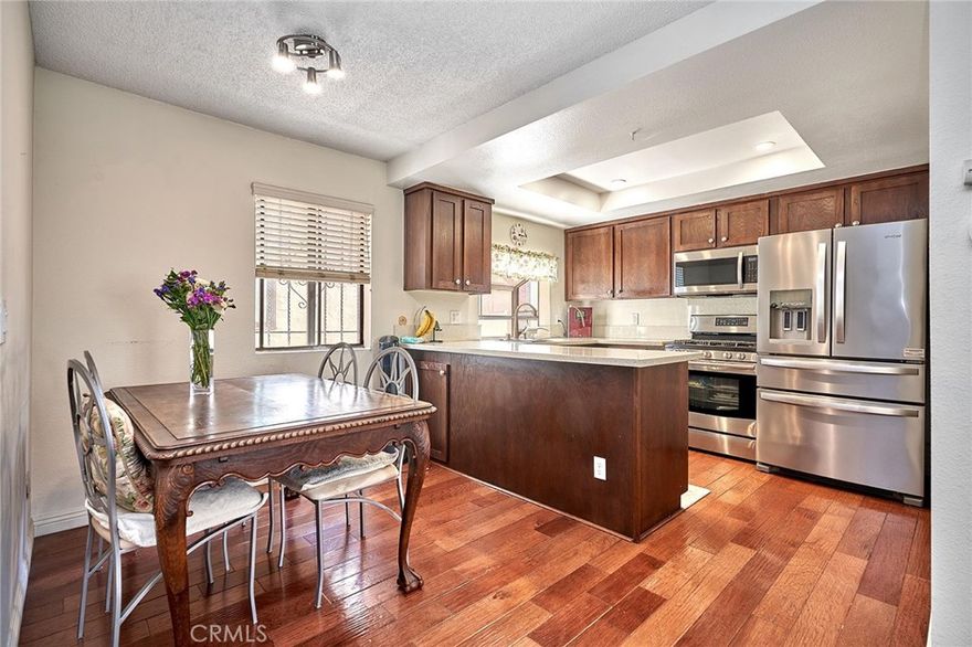 This is a rare opportunity to own a spacious 2 bedroom, 2.5 bathroom condo in a cozy community with a prime location. Upon entering, the living room greets you with hardwood floors, a brick gas-burning fireplace, modern wet bar, and recessed lighting. The kitchen boasts plenty of cabinet and counter space, a bay window, and a spacious pantry. Just around the corner is a well-situated half bathroom, and large sliding doors off the living room provide natural light and access to the enclosed patio for outdoor relaxation. Upstairs, the dual primary bedrooms afford privacy and comfort, each with its own ensuite full bathroom and double closet. The laundry room is conveniently situated upstairs between the bedrooms. Downstairs is an attached oversized 2-car garage with additional storage space. This 20-unit community has secured gated entry along with a community pool and spa. Enjoy convenient living located just steps from a park, freeway access, and major retail shopping centers.