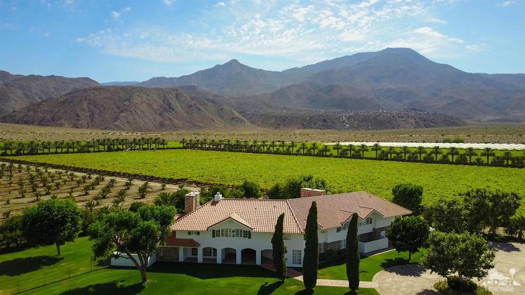 Desert Pacific Properties is pleased to present this exclusive listing. The prestigious Keck Estate offers ultimate privacy on your own 300-acre ranch, just minutes from all the dining and shopping that La Quinta has to offer. The impressive estate is adorned with breathtaking panoramic views of the Santa Rosa mountains, its own private date orchard, a sprawling 10,000 sq. ft. home with 7 beds/7.5 baths, a 3 beds/2 baths guest home, 10-stall barn with apartment, and mobile home. Take advantage of this rare and exciting opportunity to own one of the most captivating properties in the Coachella Valley!