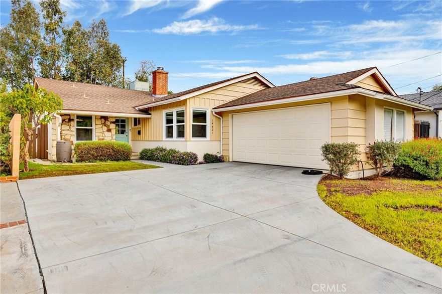 Located in a quiet pocket of Van Nuys is a beautifully updated 4-bedroom, 2-bath home offering over 1,800 square feet of living space on a generous 6,700 SF lot. Blending modern upgrades with preserved mid-century character, this home delivers comfort, charm, and an incredibly functional floor plan. From the moment you arrive, the curb appeal stands out, an expansive concrete driveway, lush landscaping, stone-accented front porch, and an inviting classic blue front door that sets the tone for the warmth inside. Step inside to a thoughtfully designed layout featuring warm laminate wood flooring with new baseboards, smooth ceilings, new double-pane windows and sliding doors, and a spacious living room anchored by a charming wood-burning stone fireplace. The fully remodeled kitchen is a true highlight, complete with tile floors, quartz countertops, white shaker cabinetry with glass inserts, subway tile backsplash, and LG stainless-steel appliances. Just off the kitchen is a cozy breakfast nook framed by large windows overlooking the front yard, a perfect daily dining space. For larger gatherings and holidays, the formal dining area sits adjacent to both the kitchen and living room, keeping everyone connected. All four bedrooms are generously sized, offering ample closet space and flexible layouts for family, guests, or work-from-home needs. The home showcases two original retro-tiled bathrooms, beautifully maintained and increasingly rare to find in such pristine condition. One includes a tub/shower combo, while the second offers a dedicated walk-in shower. Additional improvements include copper plumbing, central HVAC, retrofitted foundation, fresh attic insulation, rain gutters, updated lighting, and direct access from the two-car garage into the home, adding convenience and security. Step outside to a spacious and private backyard offering endless possibilities.  With an extended overhang shading the concrete outdoor area, along with raised planter beds, open grassy spaces, and mature trees, this backyard is perfect for entertaining, play, or adding a future ADU, SB9 lot split and more. If four bedrooms aren’t needed, one bedroom could be repurposed to allow for a larger ADU conversion utilizing the oversized garage. Commuters will love the proximity to the Amtrak Station, 405, 170 and 5 FWY, offering easy access throughout LA. With its numerous upgrades and exceptional features, this home is truly move-in ready and waiting for you to make it your own.