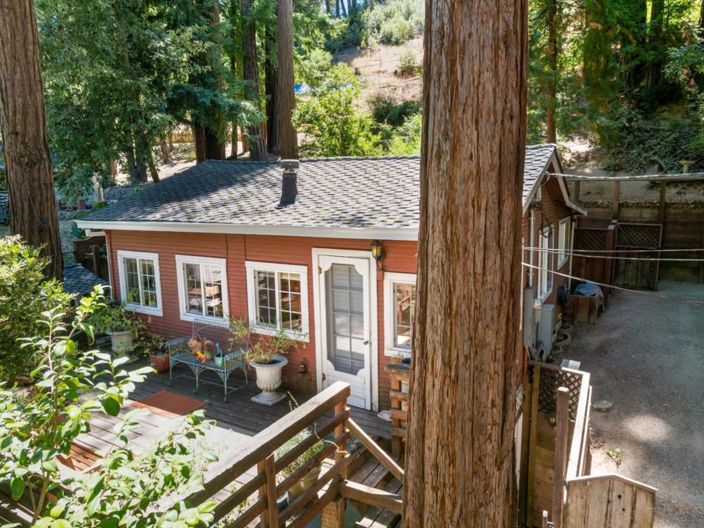 Imagine sipping coffee on the patio surrounded by majestic redwoods, just minutes from Boulder Creek's charming downtown. Whether you're seeking house-hacking opportunities, multi-generational living, or investment income - this property delivers flexibility that's rare to find. Main house is a 2 bd/ 1 bathroom cabin + detached studio unit with kitchenette & full bathroom + unfinished basement unit with full bathroom offers expansion possibilities, AND detached 1 car garage offers tons of storage. Main house features vaulted ceilings, wood paneling, vintage clawfoot tub and that authentic cabin feel. The skylights bring in so much light it will put a smile on your face. There is also a community pool, perfect for those warm mountain days! With TLC this property can be your private redwood oasis. Priced to sell and ready for your vision. Easy commute access while maintaining that peaceful mountain lifestyle. Don't miss this chance to own multiple units in desirable Boulder Creek!