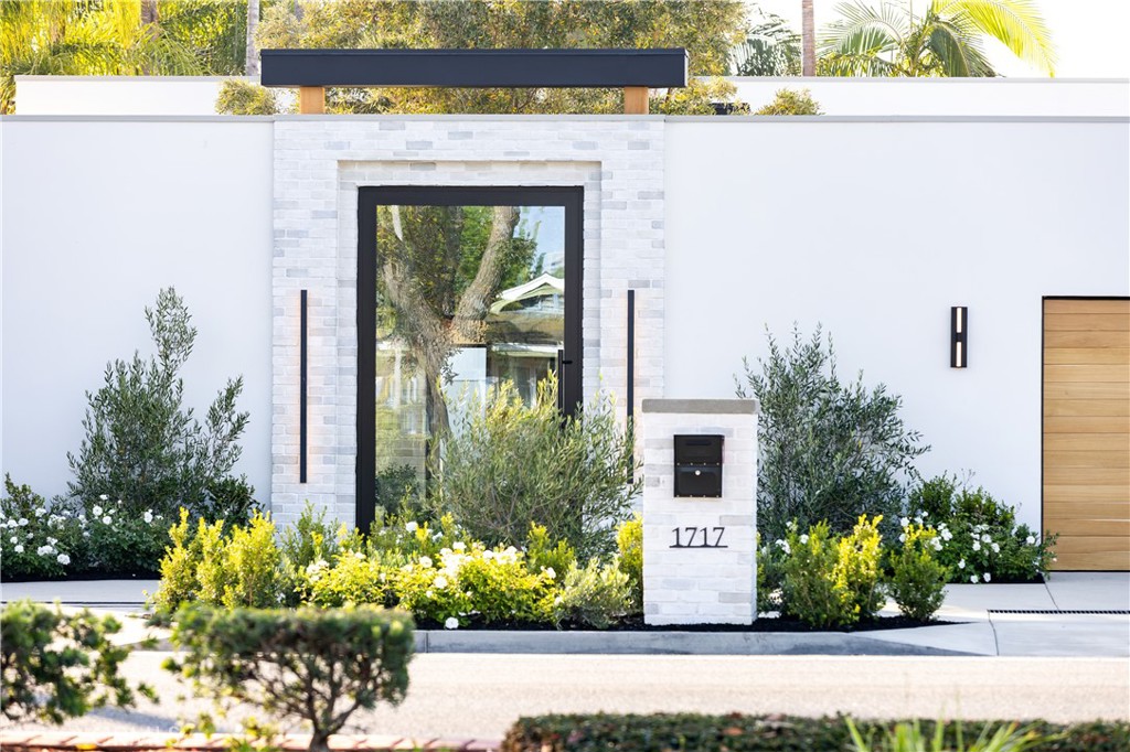 A Visionary Masterpiece by K Smith Interiors where design brilliance meets modern luxury. This newly re-constructed modern showpiece redefines elegance with bold design, seamless indoor-outdoor flow, and cutting-edge amenities. Located in the heart of Newport Beach, 1717 Irvine Ave isn't just a residence - it's a statement. From the moment you enter your 10’ glass pivot door into property you are engaged with wows of indoor finished space that is outdoor. The waterfall wall brings running water sounds deep into property with firepit, living plant walls and established Olive tree all inside property. The interior shows an expansive open floor plan with dramatic indoor merged into outdoor living spaces. The formal dining room stuns with a show-stopping chandelier and dual Thermador 92 bottle wine coolers. The sleek living room has disappearing sliders bringing the outside in and connects effortlessly to the gourmet kitchen, showcasing custom cabinetry with hidden wall walk in pantry and an oversized eat-in waterfall island. Top-tier Thermador appliances, with striking custom countertops. Disappearing glass walls create a fluid transition to the entertainer's dream backyard: a salt water smart pool and spa with micro-LED lighting, built in BBQ area with outdoor kitchen and generous outdoor space for al fresco living. The luxe primary suite is a true sanctuary with a spa-like bath with soaking tub and glass shower, dual vanities, and expansive custom walk-in closet. 2 guest bedrooms with custom closets and shared spa level guest bath. Office with custom built ins. Multiple living areas indoor and outdoor with focus for entertaining. Garage is at a showroom finish level with hexagon lighting, custom cabinets and custom floor ready for your most expensive vehicles to be seen instead of parked as you enjoy your property from what feels like a compound. Outfitted with premium technology and materials including Waterstone faucets, Custom doors/windows, Lutron lighting control, dual-zone HVAC, central audio, Wi-Fi extenders, and more - this one-of-a-kind home delivers both luxury and lasting quality in one of Newport Beach’s most coveted neighborhoods. This property demands to be seen when driving by and once seen is unforgettable.