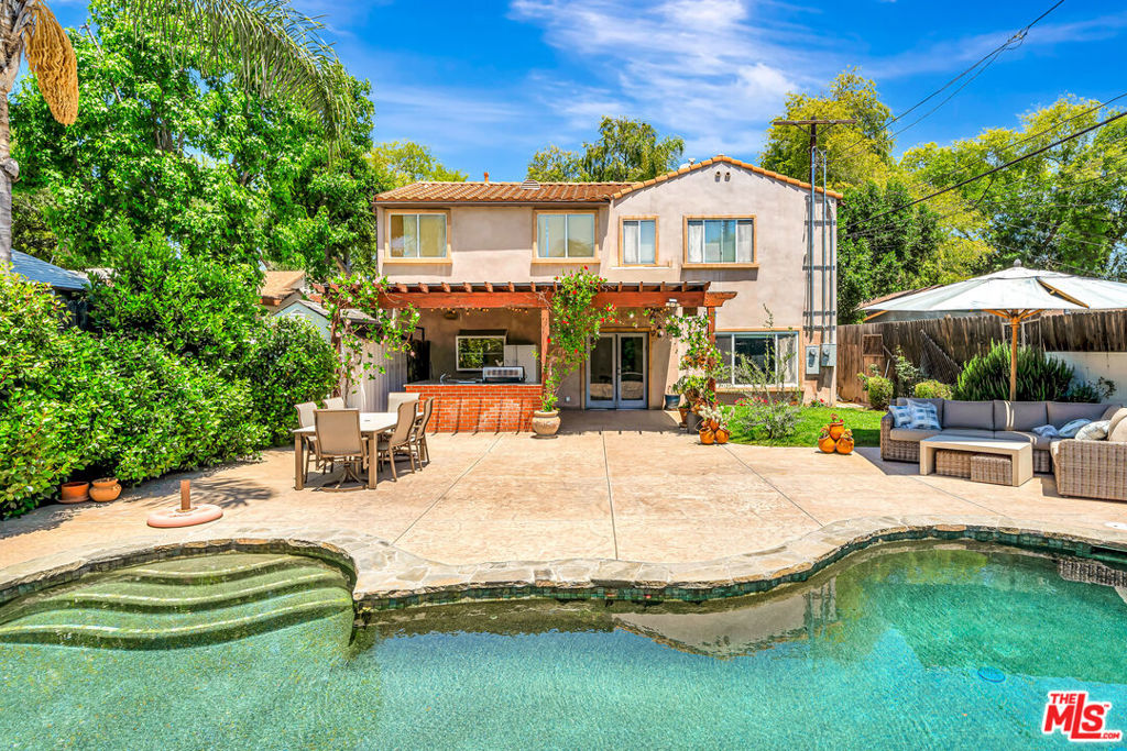 Prime location of an elegant 3-Bedroom Home with Guesthouse & Pool in Prime Sherman Oaks! Welcome to your dream retreat in the heart of Sherman Oaks where luxury meets effortless California living. This beautifully designed 3-bedroom, 3.5-bathroom main home plus a fully equipped guesthouse offers the perfect blend of comfort, sophistication, and indoor-outdoor charm. Step through a storybook arched front door into a warm, inviting interior. The spacious living room boasts high ceilings, an oversized mirror, a cozy fireplace, mounted TV, plush seating, and a pool table creating the ideal space for entertaining or relaxing in style. A convenient powder room and full laundry area are tucked near the entry for easy living. Continue through the open-concept layout into a stylish dining area with seating for eight, a chic lounge with a second TV and built-in bar, and a chef's kitchen featuring stainless steel appliances, a double oven with griddle, and abundant cabinetry perfect for the home entertainer or culinary enthusiast. Upstairs, all three bedrooms offer en-suite bathrooms and walk-in closets for maximum comfort and privacy. The luxurious primary suite is a sanctuary of its own, complete with a king-size bed, fireplace, spa-inspired bath with jetted soaking tub, dual vanities, walk-in shower, and a custom-designed walk-in closet. Outside, discover a lush, private backyard oasis designed for year-round enjoyment. String lights twinkle over a covered patio equipped with an outdoor kitchen, grill, sink, fridge, and generous dining and lounge spaces. Dive into the sparkling pool and jacuzzi, surrounded by mature greenery for ultimate relaxation and seclusion. The detached guesthouse offers endless versatility with a queen-size bed, full bath, living room, dining area, and a complete kitchen including oven, refrigerator, dishwasher, washer, and dryer ideal for guests, extended stays, or a serene home office setup with a separate entrance for privacy. The guest house can be rented for an additional price. Located on a peaceful, tree-lined street just minutes from Ventura Boulevard's renowned shopping, dining, and entertainment, plus easy access to the 101 and 405 freeways, Whole Foods, Westfield Fashion Square, and top-rated schools this exceptional property truly has it all.