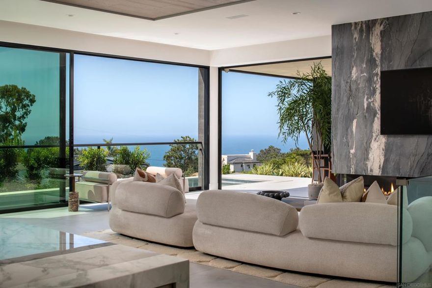 Envisioned by one of Del Mar's most celebrated architectural visionaries and designed in collaboration with a leading California luxury home builder, this incredible contemporary home in Olde Del Mar features 4 bedrooms, 4 full baths, and 2 half baths, seamlessly blending modern elegance with the natural beauty of the Pacific coast. The home’s westerly orientation captures sweeping ocean vistas extending to La Jolla, while maintaining a level of privacy rarely found in this coveted area. Stepping through the 8-foot-wide entry pivot door, you’ll be greeted by soaring 10-15 foot ceilings, clerestory windows, and disappearing nano doors that dissolve the boundaries between indoor and outdoor spaces. Flooded with natural light, this residence is the ultimate embodiment of the elevated Del Mar beach lifestyle. Crafted with the finest materials, the thoughtful design incorporates artistic angles balanced by organic wood and stone elements, creating a serene coastal sanctuary. The expansive living spaces flow seamlessly to the outdoors, where a pool with spa, firepit, and multiple lounges await for enjoying sunsets over the ocean. Exceptional features include a state-of-the-art wellness retreat, complete with a gym, sauna, cold plunge, shower, and provisions for a juice bar.  The home also boasts an executive office, a game room lounge with space for a home theater, an entertainer's bar, and temperature-controlled wine storage.  Just a short walk to the vibrant shops and restaurants of Del Mar Village, this home is a once-in-a-lifetime opportunity to own a property where timeless elegance meets contemporary coastal innovation. Live the highest standard of beachside luxury in this visionary estate.