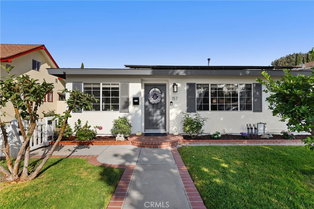 Welcome to 157 Pacific Street – A Tustin Gem with Modern Comfort & Timeless Charm. Perfectly situated in the heart of Tustin, this beautifully upgraded, move-in ready home blends modern living with classic charm. Just minutes from the 55, 5, and 57 freeways, commuting is effortless, while the vibrant energy of Old Town Tustin—with its farmers market, local restaurants, shops, and parks—is only a short stroll away. Framed by a charming white fence and lush fruit trees, this home’s curb appeal sets the tone for what awaits inside. Step inside and you’ll find a thoughtfully designed floorplan featuring three spacious bedrooms, each outfitted with custom closet organizers, and two stylishly updated bathrooms with sleek modern showers and baths. The bright, functional kitchen offers contemporary finishes and an easy layout that makes both everyday living and entertaining a delight. A custom-built barn door and a dedicated bar—complete with drink fridge and kegerator—add unique touches of personality and style. Open the front door and enjoy refreshing cross-breezes that flow throughout the home, creating an airy, welcoming atmosphere. In the backyard, discover your own private oasis. A detached 400-square-foot bonus room—fully insulated and equipped with a mini-split system—provides endless versatility, perfect as a home office, gym, art studio, or guest quarters. The expansive 20x40-foot patio cover creates an ideal outdoor living area, where you can unwind in the hot tub, gather around the gas fire pit, or relax under the shade of a massive avocado tree that produces some of the best fruit you’ll ever taste. The front yard adds even more character with mature lime, orange, and guava trees. Additional upgrades include an upgraded electrical panel with solar charger, a leased solar system for energy savings, smart home features such as recessed lighting on smart switches and a smart thermostat, and RV parking access. With modern updates throughout and true turnkey condition, this rare Tustin treasure offers the perfect blend of location, lifestyle, and convenience. Whether you’re entertaining friends, working from home, or enjoying fresh fruit from your own trees, 157 Pacific Street is more than a home—it’s a lifestyle. Don’t miss the opportunity to make this one-of-a-kind property yours!