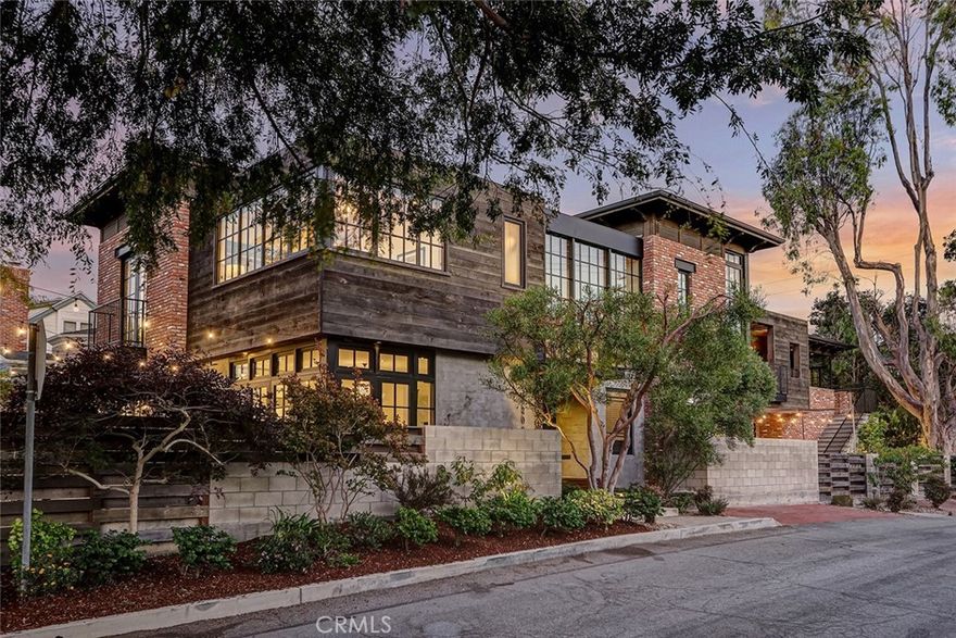 Urban Soul in the Trees! This daring and truly unique, custom home offers a soulful blend of modern design and reclaimed materials. Its wondrous spaces balance light, texture and architectural detail. Featuring dramatic glass walls, exposed beams, hand-sourced brick and 100-year-old wood, the home showcases a refined and meticulous vision. (Ask for our full feature list.) The building is almost new, but in glances, looks and feels like an older building, perhaps an old downtown commercial property that has been restored and converted for modern living. This home is no mere curiosity, however. It boasts a highly practical floorplan for family living, with multiple common spaces, terrific indoor/outdoor flow, a first-floor bedroom, a dedicated office and a guest suite with separate entrance. The rare, west-facing corner lot with alley access invites ocean breezes and gorgeous sunsets into the ample living spaces. The street is ultra-quiet, as Agnes Road ends a half block to the north – you’ll likely see more dog walkers pass by than cars. Impossible to anticipate, impossible to replicate, this home is a one-of-a-kind property that simply speaks to you. Yes, you really can have a quiet, private, landmark property that also perfectly suits your whole family's lifestyle. Featured on the cover of South Bay DIGS & LA Times Hot Property.