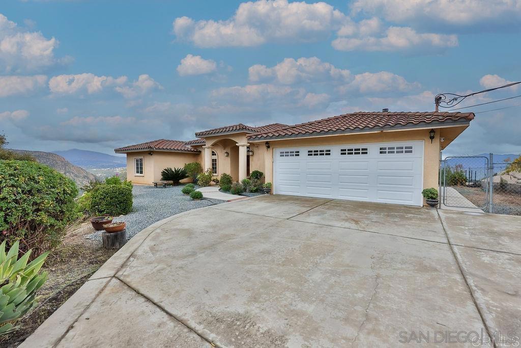 Breathtaking views with two parcels, each over 5 acres. Second parcel has a paved RV pad equipped with full hook-ups and cable. The house is beautifully updated, with walls of windows, high ceilings, 3 bedrooms plus an office, laundry room and an attached, finished garage. The large kitchen has an island, gas cooktop, granite counters and a seating area. The primary suite has a walk-in closet, private bath with dual sinks, walk-in shower and soaking tub. All the rooms enjoy enjoy the spectacular mountain views. The property offers natural boulders, fruit trees, trails, and gorgeous sunrises. Best of all, it has PAID solar. Build an ADU on this main parcel and two dwellings on the second buildable lot. The possibilities are endless.