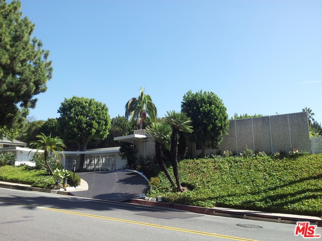 Incredible opportunity! This coveted lowerTrousdale Estates Mid-Century gem with circular driveway and motor court is rumored to have had Ed Fickett involved in the origins of the architectural plans completed by Howard Frank. Ready for new owner with creative vision to transform this corner lot into a walled and gated Estate. Originally designed for indoor/outdoor open-concept living with tall walls of glass opening to long veranda and grassy yard, this 4 bed+5 bath home with generous living spaces provides the opportunity to upgrade the interiors for a 21st Century look while maintaining the integrity of its unique & elegant Mid-Century Modern architecture. Twinkling city light views add to the allure of Trousdale Estates living among A-list celebrities and billionaires and close to Beverly Hills shopping & fine dining. Artist renderings provided are conceptual and not based on architect plans. Great chance to reimagine and customize this iconic Mid-Century home!