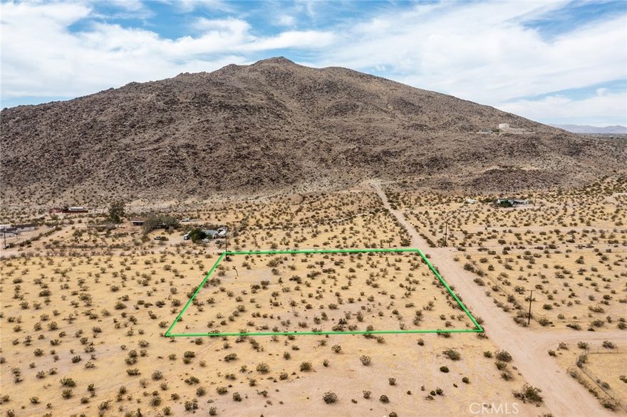 Excellent 2.26-acre parcel located next to the Bartlett Mountain Range in North Joshua Tree. SCE electrical poles are adjacent to the property and Joshua Basin Water District water-mains are in the street to provide a water-meter. Property has been surveyed. Green lines in pictures demarcating boundaries are approximate; APN: 0600-101-28