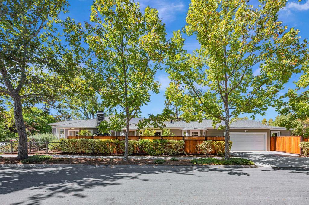 This delightful single-level home on a lush tree-lined street is situated in the heart of the charming Mt Carmel neighborhood. It offers a perfect blend of old world charm with modern functionality. Meticulously maintained, this home features a professionally landscaped drought resistant front yard, travertine stone walkway and porch, an enclosed sunroom at the entrance, freshly painted, refinished hardwood flooring, multiple skylights, inviting living room with beamed ceiling, fireplace and an adjoining Den. The kitchen is equipped with cherry cabinets, granite counters, ss appliances - Bertazzoni Italia 6 burner's stove, and opens to a spacious dining area w/ French doors that leads to a private patio with Connecticut blue stone, a perfect place to BBQ and entertain. Large primary bedroom w/ ample custom cabinetry and a remodeled bath. Separated by the large 2-car garage, the 4th bedroom, 3rd bath & kitchenette has it's own entrance (ideal for extended family) & includes a private patio and garden area with raised planters. Blocks from the vibrant Downtown Redwood City's shops and restaurants, Whole Foods, local schools (North Star Academy) CalTrain, popular Stafford Park with its weekly summer concerts, and minutes to major commute corridors to Silicon Valley & San Francisco.