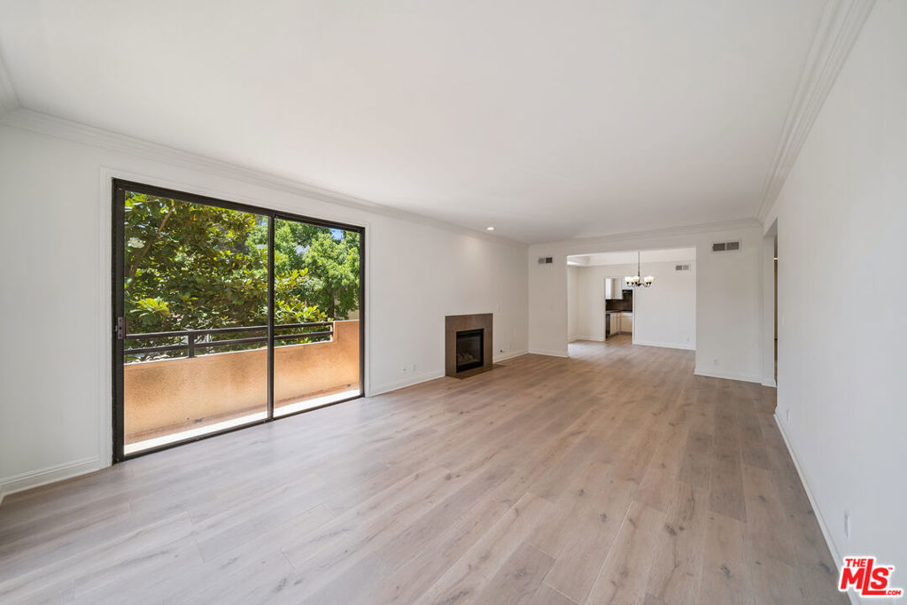 Tenant Pays for Gas, Electric, Trash. Included: Water, Landscaping. Tandem Parking included. Laundry Hook-ups In unit !!! Very Close to Cedars Sinia !!! Welcome to your newly updated Beverly Hills adjacent retreat! This spacious first-floor front unit offers 2 bedrooms, 2 bathrooms, plus a versatile den perfect for a home office or guest room. Located just a 2-minute walk from Cedars-Sinai, you'll enjoy the convenience of city living in a quiet, secure building with controlled access. Step inside to find an abundance of natural light streaming through massive patio doors that open to your private balcony. The separate dining and living areas are highlighted by elegant recessed lighting, a wet bar for entertaining, and an electric fireplace (for show) that adds a cozy touch. The primary suite features a massive walk-in closet and an en suite bathroom with a separate shower and relaxing jacuzzi tub your own private sanctuary. Additional features include: Central A/C for year-round comfortIn-unit washer/dryer hookups Beautiful wood flooring throughout Tandem parking included Don't miss your chance to call this stunning space home!
