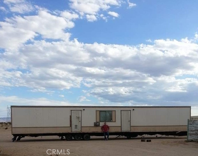 There are 3 mobile homes. One is permitted and he's in the process of getting permits for the other two. There are three large storage containers that were put in place during COVID. So he's in the process of getting permits for those also. There is a small auxiliary barn that has a new roof and he is installing new doors. The entire five acres is enclosed by a chain link fence.