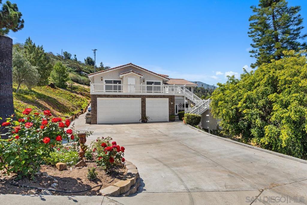 Welcome to the ultimate multigenerational masterpiece—where privacy, practicality, and panoramic views collide in spectacular fashion! Tucked just off the 94 and only minutes from all the amenities of Rancho San Diego, this one-owner, 5-bedroom, 3-bathroom, 4,019 sq. ft. home has everything you didn’t know you needed—plus an elevator (yes, really), a massive 1,121 sq. ft. garage, and even a fire hydrant right at the top of the driveway for added peace of mind. (Go ahead and tell your insurance agent!)Let’s talk versatility: Downstairs, you’ll find a cozy bonus room with a fireplace and built-in bar—ideal for your home theater, in-law suite, or easily converted into a full second kitchen for true multigenerational living. Upstairs, you’ll glide up in the elevator (because why not?) and be greeted by breathtaking mountain views, a spacious primary suite, and a sun-drenched family room with its own viewing terrace.The oversized kitchen is an entertainer’s dream, featuring upgraded appliances, granite countertops, and storage galore inside custom cabinets that would make even a pro chef swoon. Hosting gatherings? Step outside to the covered deck and upgraded pool with new equipment—it’s the perfect setting for barbecues, birthdays, or quiet evenings under the stars.Want energy efficiency? You got it. This home boasts a 2024 roof, leased solar, and space to stretch out, grow in, and truly thrive. Whether you're accommodating aging parents, raising a big family, or just want room to live life large, this home flexes with you. List of Improvements Kitchen appliances: 2023 Oven GE All Profile 2023 Dishwasher GE All Profile 2022 Refrigerator GE All Profile 2023 Microwave GEAll Profile Washer and Dryer 2023 GE 2024 painted the following rooms Primary Bedroom, Hallway, Family Room,Upstairs and Kitchen New Roof 2024 Painted garage floor 2023 Septic Certification 2024 Termite Tented 2024 Replaced all viewing terrace upstairs outdoor railing and stairs 2022 New paint on viewing terrace floor 2024 Upgraded downstairs decking 2024 and painted Viewing Terrace installed 2022 Replaced garage door trim 2024 Upgraded driveway concrete 2024 Resurfaced all pool, spa, coping, patio and retaining wall 2024 New pool equipment 2023 Electric water heater replaced approx. 4 years ago