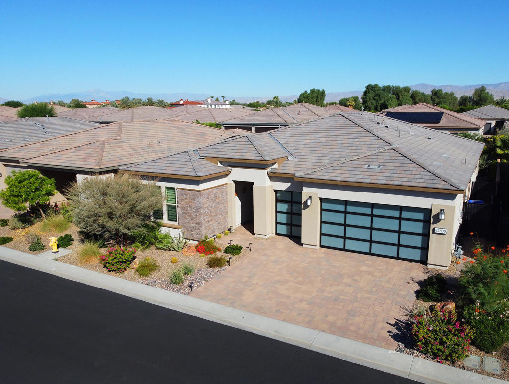 Welcome to your new home in the spectacular Trilogy Polo Club! This premier, gated, 55+ community offers everything you need for active adult luxury living. This exceptional home, built in 2022, boasts 3 bedrooms, 3 baths, plus a large Den/Media room. One of the largest models, it offers 2,367 SqFt, with every bit of it showcasing beautiful ceramic floor tile. Nearly every upgrade is included: Quartz countertops and coffee bar, a Kohler farm sink, Kohler bath fixtures, 9-foot doors, a spa like primary bath featuring beautiful tile shower, rainfall glass shower, a huge LED mirror, and a walk-in closet with built-in cabinetry. Experience great indoor-outdoor entertaining as you pass through the triple slide patio door system to the extend covered patio space. Full paver extensions on the back patio and both sides of the home include an upgraded drainage system. Upgrades for the large 3 car garage include a 4 foot garage length extension, allowing for all full size vehicles, custom glass panel doors, a 24,000 BTU mini split AC, a 60 Amp EV charging outlet, a 20 year water softener/filtration system, ceiling storage system, tankless water heater, and a heavy duty security safe. The entire garage also had wall insulation added to help keep it cool. The Polo Club 25,000 Sq Ft clubhouse, includes a restaurant, bar, fitness center, game room, recreation rooms, tennis, pickle ball, pools, bocce ball, putting green, and endless activities. See attached Club brochure. Membership initiation has been paid, and just the transfer fee would be required. Don't miss this opportunity to enjoy the best desert living lifestyle!