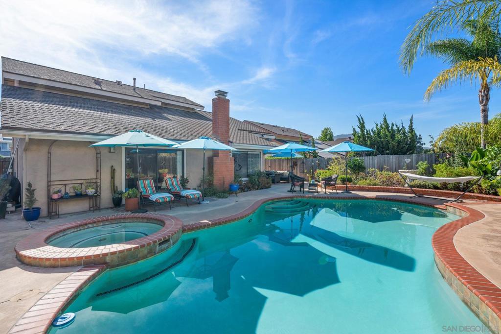 This beautifully cared-for La Mesa residence radiates pride of ownership, offering over 2,500 square feet of thoughtfully designed living space with a seamless connection between indoors and out. The entry-level primary suite features an ensuite bath and direct access to the lush backyard—complete with a sparkling pool, spa, and multiple patios perfect for enjoying San Diego’s year-round sunshine. Vaulted ceilings and an open floor plan fill the home with natural light, while a spacious family room off the kitchen provides an ideal space for relaxing or entertaining. Upstairs, you'll find two additional bedrooms, a full bath, and a versatile bonus room—perfect as a home office, gym, den or guest space. Recent upgrades include laminate flooring, fresh paint, new baseboards, LED lighting, resurfaced/re-tiled pool with new panel & pump, roof resealed, and extensive plumbing updates. Finished with refreshed landscaping, terracotta-tiled deck, and brick patios—this home blends comfort, efficiency, and timeless appeal.