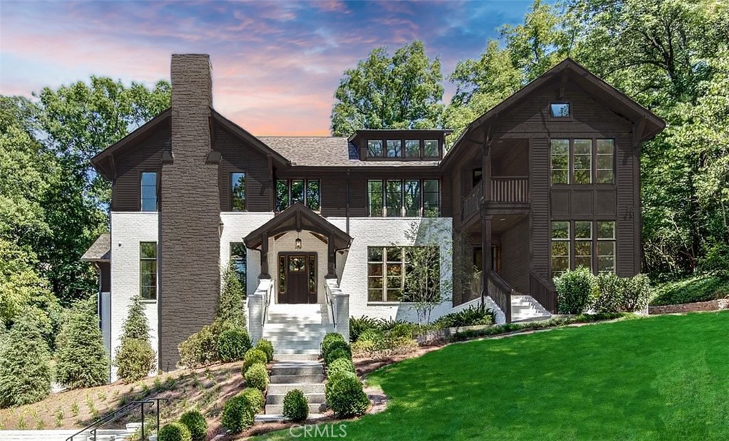 Tucked at the peaceful end of a cul-de-sac in one of Nashville’s most coveted neighborhoods, 3530 Trimble Court is more than a home—it’s a living narrative of grace, intention, and elevated Southern living. Set on 1.14 private acres, this 5-bedroom, 6-bathroom residence is a masterclass in thoughtful luxury, where every room has a purpose and every detail tells a story.
Step inside and let the natural light lead you through wide-plank hardwood floors, soaring ceilings, and warm, open spaces designed for gathering and grounded living. A main-level office offers a quiet escape for focused work or inspired ideas, while a breezy upstairs loft provides a perfect flex space for reading, relaxing, or play. The main-level primary suite offers serenity and seclusion, with spa-like finishes and a connection to the home’s quiet elegance.
The story takes its most inspired turn downstairs—into a level where artistry and utility intertwine. Step into the speakeasy and temperature-controlled wine cellar, where a dramatic root structure—“Rooted in Connection”—anchors the space. Once the intertwined base of two Honey Locust trees, it now symbolizes unity and growth, framed by a 9-foot steel wall finished in gunmetal tones. The effect is cinematic—a space for sharing stories, quiet moments, and lasting memories.
Just steps away, a hidden treasure: a 300-square-foot custom closet and dressing room, complete with its own heating and air. Tucked beside the wine and whiskey grotto, this boutique-style sanctuary blends function and fantasy—ideal for curated collections or seasonal wardrobe transitions. Also on this level is a state-of-the-art golf simulator and access to the 3-car garage, rounding out the home’s lower-level experience.
In the main living room, the heart of the home, stands Jacob’s Ladder—a 700-pound root sculpture from the Osage Orange Tree, revered as the hardest wood in North America. Once used for bows and arrows, it now rises nearly 20 feet toward the ceiling, bathed in natural light and symbolic of the soul’s upward journey. It’s more than art—it’s a spiritual statement.
Outside, the magic continues across lush, landscaped grounds—private and perfect for peaceful mornings or spirited evening gatherings beneath Tennessee skies. 3530 Trimble Court is not just a home—it’s your next chapter.