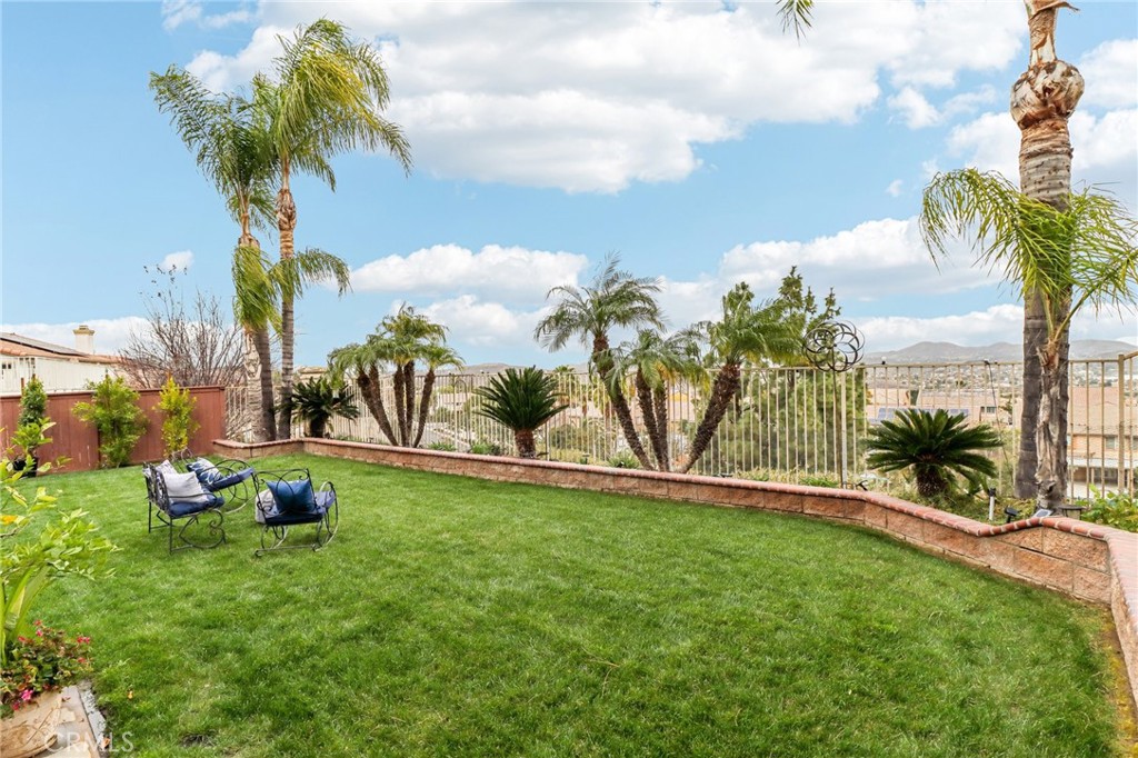Breathtaking 5-Bedroom View Home with Private Casita in Tuscany Hills! Luxury, versatility, and panoramic views await in this exceptional Tuscany Hills masterpiece! Step into elegance as you enter through a private gated courtyard and discover a separate casita—perfect for guests, remote work, or multi-generational living. This beautifully upgraded 5-bedroom, 3-bathroom residence is perched on a premium view lot, offering sweeping vistas of rolling hills and city lights. Inside, you're welcomed by a dramatic two-story foyer, expansive large-plank LVP flooring, and soaring ceilings bathed in natural light. The formal living and dining rooms impress with an electric fireplace, designer wall sconces, and a statement chandelier that exudes sophistication. The heart of the home is the expansive family room with a gas fireplace and French doors that open to a serene backyard oasis. It flows effortlessly into the gourmet kitchen—fully equipped with LG stainless steel appliances, double ovens, a 5-burner cooktop, walk-in pantry, granite countertops, custom tile backsplash, and a delightful breakfast nook that opens to the courtyard. Downstairs features a full bedroom and bathroom, ideal for overnight guests or in-law accommodations. Upstairs, you'll find a tech center, two generous secondary bedrooms with walk-in closets, and one with its own private balcony. The luxurious primary suite is a true retreat, featuring a cozy gas fireplace, tranquil sitting area, and private balcony with jaw-dropping sunrise and sunset views. The spa-inspired bath includes a jetted tub, separate shower, dual vanities, a makeup station, and dual walk-in closets. Outside, the expansive patio is designed for entertaining, relaxing, and savoring the breathtaking views—all while enjoying the benefits of solar energy for reduced utility costs. Just minutes from shopping, dining, and the award-winning Tuscany Hills clubhouse, this home seamlessly blends comfort, elegance, and lifestyle. Homes like this rarely come to market—schedule your private tour today and experience the magic of Tuscany Hills living!
