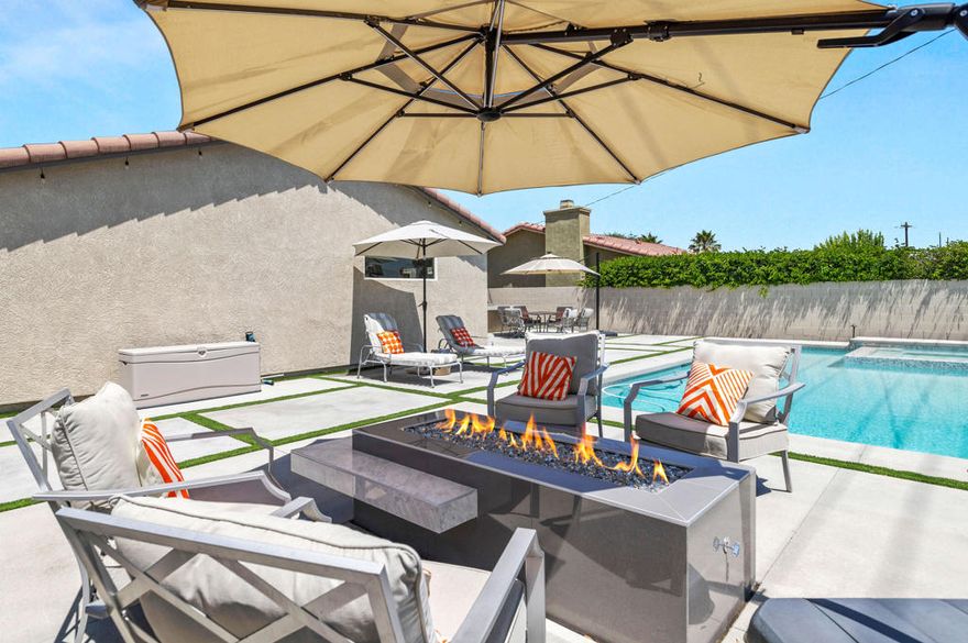 Welcome to 2144 Marguerite Street, a beautifully reimagined retreat in coveted South Palm Springs!  This 4 bedroom, 2 bath home features soaring ceilings and an open floor plan, designed for entertaining and everyday comfort. Completely transformed, the home features ceramic wood-tile flooring throughout, creating a warm, modern aesthetic. The kitchen is a true showpiece, showcasing stainless steel appliances, a gas cooktop, quartz countertops, striking cabinetry, and a designer backsplash. The living area is anchored by a dramatic fireplace, adding both style and ambiance.Both bathrooms have been fully remodeled with oversized walk-in showers and sleek quartz countertops, delivering a spa-like experience. Step outside to a backyard that has been entirely redone to maximize desert living--featuring a gorgeous pool and spa, plus a custom outdoor kitchen perfect for al fresco dining, and entertaining under the stars. The front yard boasts thoughtfully designed desert landscaping, offering beauty with low maintenance.  Leased solar means little to no electric bills!  Located on fee land that you own and no HOA, this property is ideal as a primary residence, second home, or income-producing vacation rental. At this time, the neighborhood is currently at just 16.67% vacation rental capacity, offering buyers the opportunity to obtain a short-term rental permit, making this an especially attractive, lucrative investment.  Situated on a very quiet street, you're conveniently close to Trader Joe's, Target, and just minutes from Downtown Palm Springs.  This pristine South Palm Springs home truly checks every box. Make your appointment today--this one will not last!