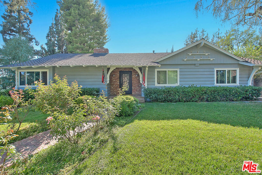 This charming property boasts a prime corner lot adorned with lush landscaping and mature trees. The traditional design exudes warmth, highlighted by a stunning wood-beamed formal living room with a massive stone fireplace. The family room features a cathedral ceiling, a second fireplace, and a built-in BBQ. The chef's kitchen is equipped with top-of-the-line appliances, including a Sub-Zero fridge and Viking double convection oven. Enjoy the sun-drenched dining area with French doors leading to a private backyard oasis complete with a pool and pool house. The spacious master suite offers two walk-in closets, updated bath, and French doors to the serene backyard. Additional highlights include a separate guest room and office, plantation shutters. As a special bonus, the housing provider includes bi-weekly light cleaning, ensuring your home stays pristine without the hassle.