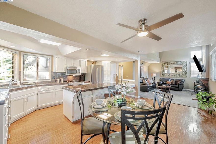 Beautifully updated corner-lot home, now featuring a brand-new roof (installed October 2025), move-in ready with warm hardwood floors and modern finishes. The open and expanded kitchen features granite counters, a center island with seating, stainless steel appliances, pantry, and open flow to the dining space and backyard—ideal for family gatherings or relaxing outdoors. A rare rear pad with double side-yard access and gated entry offers flexibility for RV or utility parking (no hookups included), storage, or future outdoor customization. The first floor includes a versatile retreat room and full bath—perfect for family, guests, or a home office—offering true multigenerational convenience. Upstairs, the spacious primary suite provides a peaceful retreat with a remodeled bath, dual sinks, a tub/shower combo, and generous closet space. No HOA, and just steps from Pleasanton’s nearby park with tennis, volleyball, and playgrounds. Top Pleasanton schools are nearby, and freeway access (580/680) and downtown are only minutes away. Note: virtual imagery shows recreational vehicle for illustrative purposes only; no hookups included. Buyer to confirm fit, access, and suitability.