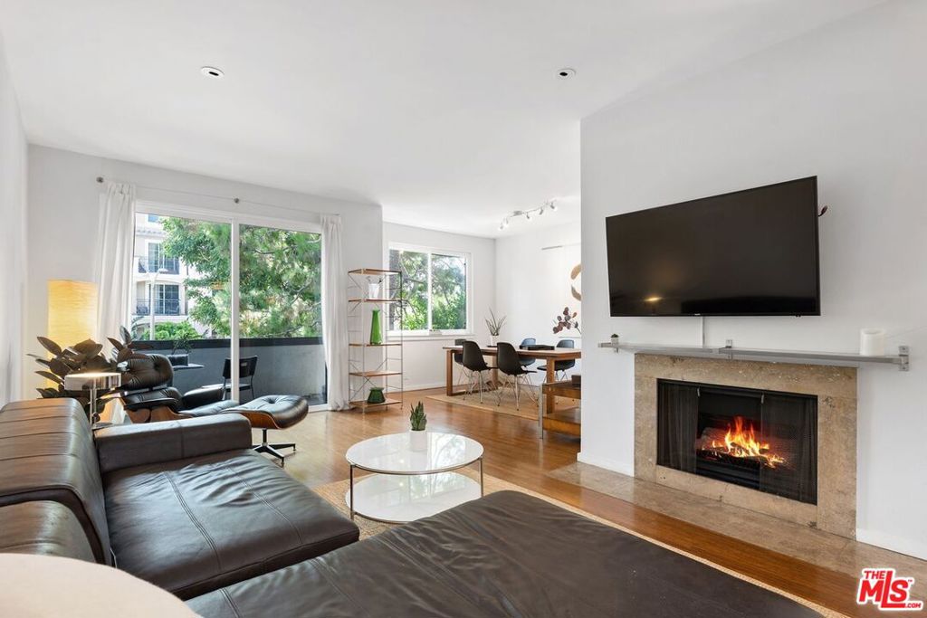 Enjoy resort-like living in this nearly 1,500 square feet updated corner unit with 2 balconies in the highly desirable Silver Strand neighborhood of Marina del Rey. Double doors open to a formal entry with large closets. A spacious and airy living/dining area has beautiful hardwood flooring, a gas fireplace, recessed lighting, high ceilings, and sliding doors that open to a generous balcony. A thoughtfully designed office nook tucked into the living room offers a dedicated workspace - perfect for remote work, study, or creativity. The galley kitchen is equipped with stainless steel appliances, granite countertops, a breakfast nook, and ample cabinet and counter space for cooking and entertaining. Unwind in an expansive main bedroom with its own private balcony, a walk-in closet, and a spa-inspired en-suite bathroom with a beautifully updated dual vanity, a separate shower and a soaking tub. The generously sized second bedroom with large closets makes a great guest retreat. From the hallway is a modern second bathroom with walk-in shower. Practical touches such as 2 dedicated side-by-side parking spaces, an in-unit laundry room with washer and dryer and an additional closet, double pane windows, central HVAC, controlled access with intercom, and an extra storage space outside the unit, help simplify your life. Residents enjoy access to luxurious indoor and outdoor amenities including a year-round heated pool and spa, two tennis courts, a pickleball court, fitness center, elevators, a recreation room, and dry saunas. This vibrant coastal community is located minutes from Abbot Kinney Blvd, Venice Canals, great restaurants and shops, water taxi, Trader Joe's, bike path, farmer's markets, Runway Playa Vista, Santa Monica, and Culver City.