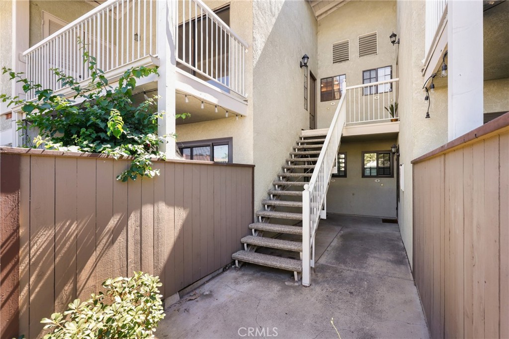 Welcome to Village Homes in Tustin! This second-floor condo is tucked away in the highly desirable, gated community of Village Homes and boasts an abundance of natural light. The spacious primary suite features its own en-suite bathroom, walk-in closet and ceiling fan, creating a private retreat-like atmosphere. The inviting living room centers around a cozy gas fireplace, ideal for relaxing evenings. Just off the living area, the dining space flows seamlessly into the kitchen—perfect for entertaining guests. Stainless steel kitchen appliances are all included and ready for you to move in! Additional highlights include in-unit stackable laundry, extra storage located on the private balcony, and a dedicated carport space. Enjoy low-maintenance living with HOA-covered amenities such as a resort-style pool, soothing spa, outdoor shower, clubhouse, and beautifully maintained grounds. Located in the heart of Tustin, this home offers easy access to major freeways, award-winning schools, neighborhood parks, and popular shopping and dining destinations like The District and Tustin Marketplace. Whether you're a first-time buyer, downsizer, or savvy investor, this home checks all the boxes!
