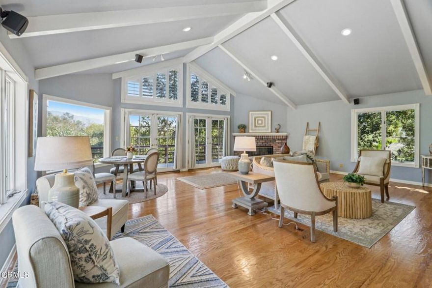 Located in the highly sought after Linda Vista neighborhood, this private single-level home offers 3 bedrooms, 2.5 baths, and approximately 2,460 sq ft of living space on a 20,000+ sq ft lot. Behind gates, a long driveway leads past a waterfall and pond to a peaceful setting surrounded by mature landscaping and mountain views. The living room features vaulted ceilings, hardwood floors, a brick fireplace, and French doors opening to a view deck. The adjoining dining/family room has a second fireplace and ample space for entertaining. The primary suite includes vaulted ceilings, built-ins, a third fireplace, and direct deck access. The kitchen offers newer stainless steel appliances, tile counters, and a breakfast nook. Outdoor areas include multiple decks, a grassy yard, spa, and garden pathways. Additional features: central air, laundry room, and oversized 2-car garage with workspace. Convenient to the Rose Bowl, Old Town Pasadena, and major freeways.