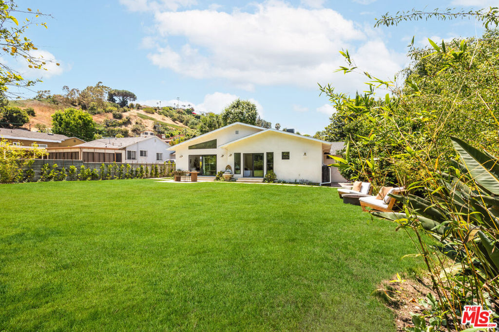 For the discerning design lover, this fully remodeled 4-bedroom, 3-bathroom home in Baldwin Vista is a rare mix of clean design, timeless materials, and elevated craftsmanship, all set on an expansive 10,000+ sq ft lot - almost a quarter of an acre. A dramatic entry reveals soaring vaulted ceilings and a striking sense of volume and natural light, while solid oak hardwood floors and natural light create a warm, gallery-like atmosphere. The dreamy great room is open and airy, and seamlessly connects to the outdoors, with a large patio door open to one of the biggest backyards around. The transom window spills endless light into the living area, highlighting the vaulted ceilings. The custom-designed kitchen is a gourmet centerpiece, outfitted with warm cabinetry, quartz countertops, and premium appliancesa space where form and function coexist seamlessly. Bathrooms are curated with terrazzo flooring, beautiful wood vanities, and elegant fixtures that echo midcentury influences. Each of the four bedrooms offers calm, intentional design perfect for creatives who crave both inspiration and rest. Newer systems ensure peace of mind, with the massive lot offering a canvas for endless outdoor enjoyment, a potential pool, or even a possible future ADU. The lush landscaping includes a veritable farmers market of mature fruit trees including : pomelo, mango, blood orange, loquat and lemon. Updates include new 200 amp electrical panel plus car charging plug, new plumbing, new windows and doors, and central HVAC. And ample parking with a large garage with both front and back garage doors - so that you can finally house your car collection in the manner it deserves. The neighbors are warm and welcoming, and happy to extoll the wonders of Baldwin Vista - one of the best kept secrets in Los Angeles. Gates going directly from your neighborhood lead to the 400 acre Kenneth Hahn Park, with 360 degree views of LA. You are moments away from the new Whole Foods on Jefferson. You're also just minutes from the heart of Culver City - ready to enjoy The Culver Steps with Erewhon and Salt 'n Straw, Destroyer for a fun brunch, Vespertine for a special dinner, Citizen Public Market to hop amongst the gourmet food booths, Hi-Lo Liquor, Cognoscenti Coffee,and so much more. Just a hop and a skip away, you have so many fun options in West Adams: enjoy Highly Likely Cafe, Michelin-featured Cento Pasta, charbroiled deliciousness at Miz La La, fabulous meals at Alta, great wine at Adams Wine Shop, delicious Mian noodle, yummy Bee Taqueria, enjoy a firepit-side dinner at Johnny's on Adams, amazing cauliflower queso at Chulita and more. Minutes away, enjoy local favorites such as: Hilltop Coffee (delicious coffee plus snacks and beignets!), Jon & Vinny's/Helen's Wines, Simply Wholesome (housed in a Googie style architectural building!), Puerto Nuevo and more. Just a little further, have fun on the 13 mile Park to Playa bike trail (from the Baldwin Hills Parklands to the Pacific Ocean!). You're just minutes from both the Expo and Crenshaw train lines with the latter connecting via the transit center directly to the airport. Tucked in one of LA's most architecturally rich and quiet neighborhoods, this home is just 15 min from DTLA, 5 min from Culver City, and 20 min from the beach! Designed and staged by The Art of Houses.