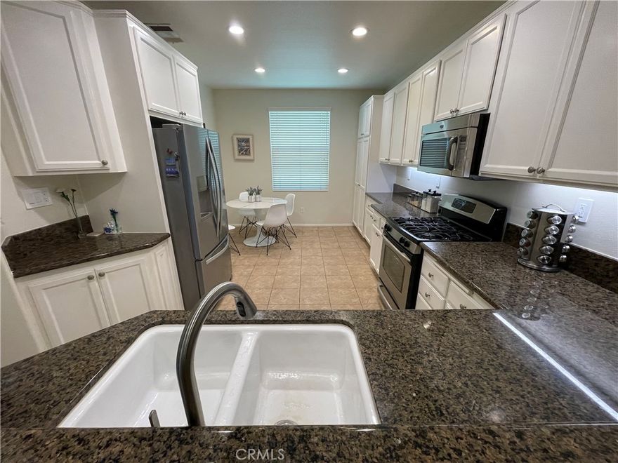 The biggest garden home in the Prestigious guard-gated community of "The Porter Ranch Promenade". Highly upgraded and never been rented. Engineered wood flooring and fresh paint. Three large bedrooms with 3 full baths. This meticulously designed home offers a perfect blend of elegance. This larger model has a downstairs bedroom and full bath, for that multigenerational living arrangement. The gourmet kitchen has a sleek granite countertops, stainless steel appliances and a nice space for a kitchen table that looks out to the front yard and park area. Also there is a gourmet kitchen/dining room bar, open to each other. The adjoining living room has recessed lighting and a cozy fireplace. A sliding door opens to the private patio area for that entertaining. Upstairs is a separate laundry room with recessed lighting and a built-n office/study area nestled between two ensuite bedrooms. The master suite has a wonderful window that has a view and lots of natural light. The luxurious primary bathroom features dual sinks, a large walk-in closet. More highlights of this home include a two car attached garage with great cabinets and an epoxy floor. The Promenade residents enjoy two parks and a resort like pool and spa. Conveniently located just a hop and a skip away is the new "Vineyards at Porter Ranch offering many restaurants, Whole foods and a AMC multiples theater.