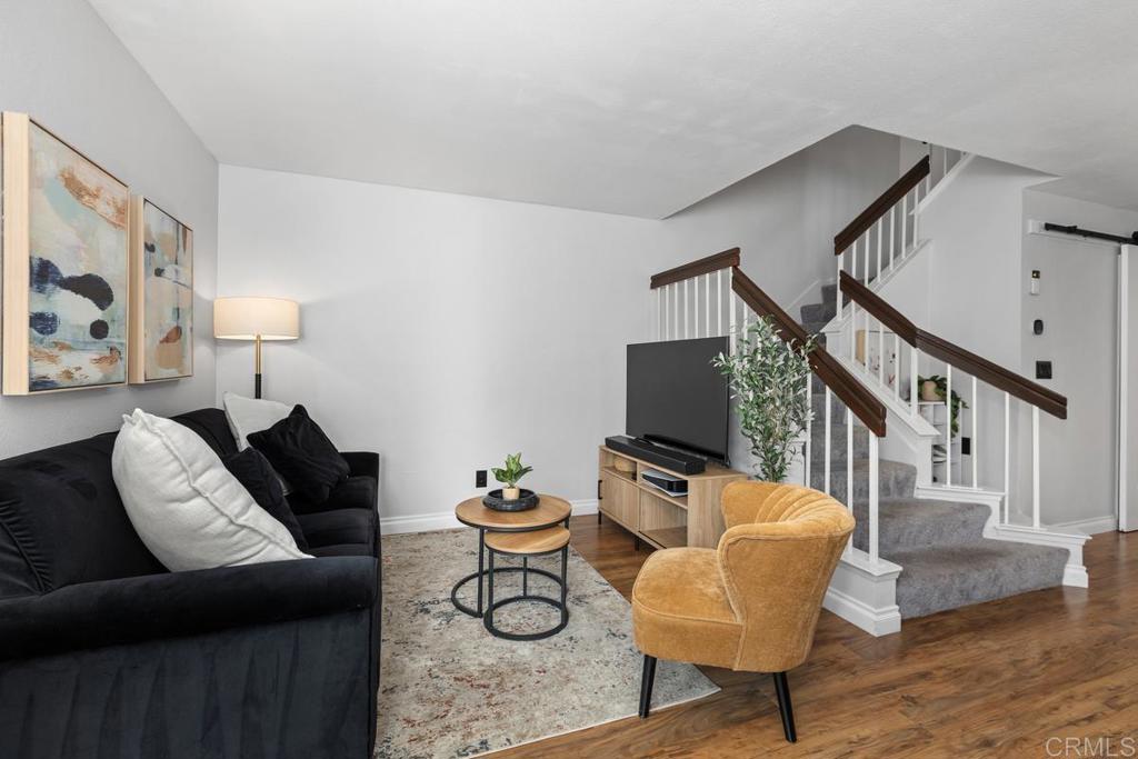 Beautifully designed end unit that lives like a single family home with two spacious primary bedrooms upstairs and a half bath on the main floor PLUS an office. Sunlight fills the home through abundant windows with custom treatments, highlighting vaulted ceilings and custom closet systems. Enjoy new central heat and air, plus a private office on a wraparound patio with its own entrance. The modern kitchen features an induction stove and roomy pantry, perfect for entertaining in the open concept layout. Community amenities include a pool, spa, playground, dog run, lush grounds and two parking spaces, all with affordable HOA dues making this the perfect place to call home.