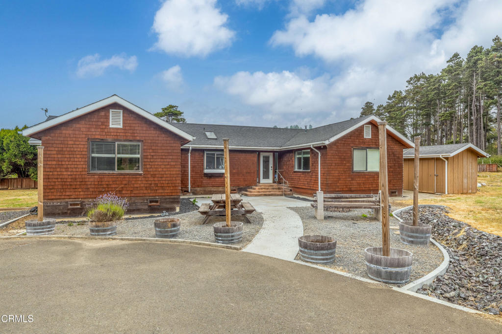 Coastal Live/Work Property with Home, Studio & Massive Shop on 2 Fenced Acres - Minutes from Town & TrailsTucked away in a private, quiet neighborhood set back from the highway, this unique coastal property offers space, flexibility, and functionality on two flat, cleared, and fully fenced acres. Just 3 miles from Fort Bragg and 5 miles from Mendocino, and less than a tenth of a mile from the trailhead to Jughandle State Park and beach access, the location is ideal for both convenience and outdoor living.The 1,700 sq. ft. main home features three bedrooms and three bathrooms, a central heating system, and a wood stove for cozy, efficient warmth. The layout is open and practical, designed for everyday comfort.Just steps from the main house, an 800 sq. ft. art studio provides additional living or workspace. Complete with a full kitchen, bathroom, washer and dryer, and a loft, it's perfect for guests, rental potential, or creative use.A major standout is the 80' x 40' steel shop, built for serious storage and functionality. The shop features:Four 14' x 14' roll-up doors, including two pass-through baysSpace to accommodate boats, RVs, trucks, and equipmentUpstairs flex space with a pool table and bar areaDownstairs gym, workshop, and storageWood stove to keep the space warmOutside, the property includes a large automatic gate, ample parking on both asphalt and gravel, and open space for staging, expansion, or outdoor use. The property exceeds CAL FIRE's defensible space standards, offering enhanced fire safety and peace of mind.Additional features include:Productive drilled wellFiber optic internet availablePlenty of room for live/work setups, creative studios, home-based business operations, or contractor staging.This is a rare opportunity to own a versatile, move-in-ready property in one of the most sought-after areas of the Mendocino Coast--just minutes from town, the ocean, and miles of protected trails.