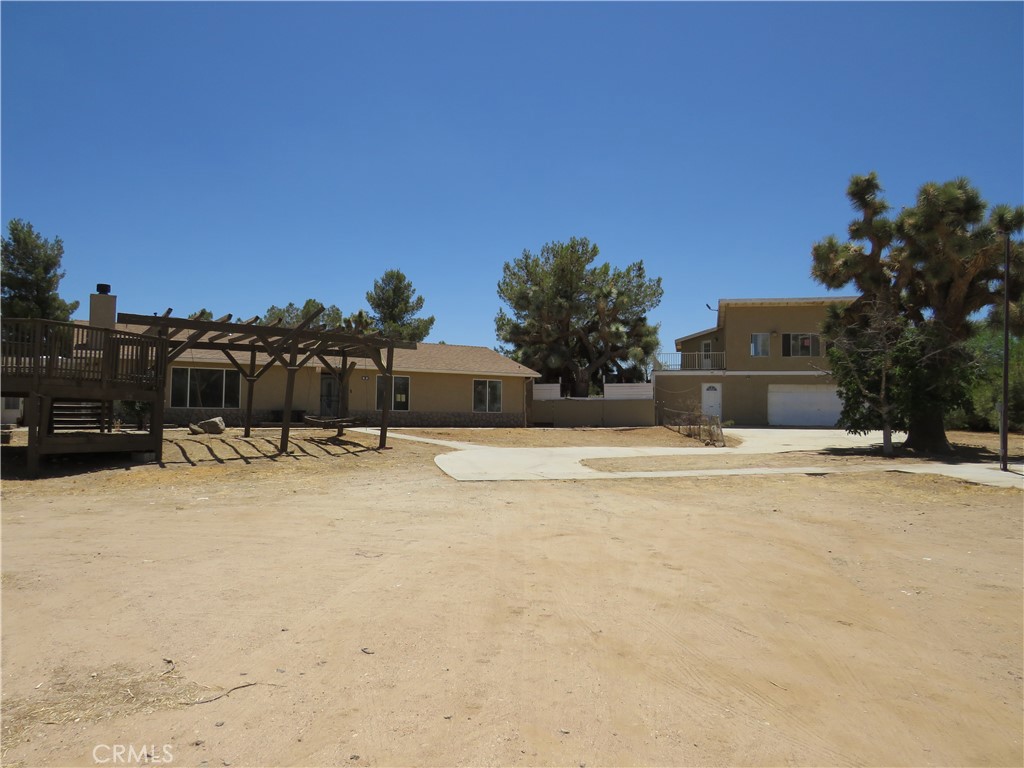 Need lots of space? This is the place. The large lot is 2.3 acres with the main house consisting of three bedrooms, two baths, living room, kitchen, dining area, and laundry room. It is approximately 1674 square feet. It also has three additional rooms not included in the square feet. There is a two-car detached garage with additional room on the side and a room above the garage with a deck off the upper room. The room above the garage has been converted to a studio apartment with a kitchen and a full bathroom which could be used as guest quarters or an ADU.