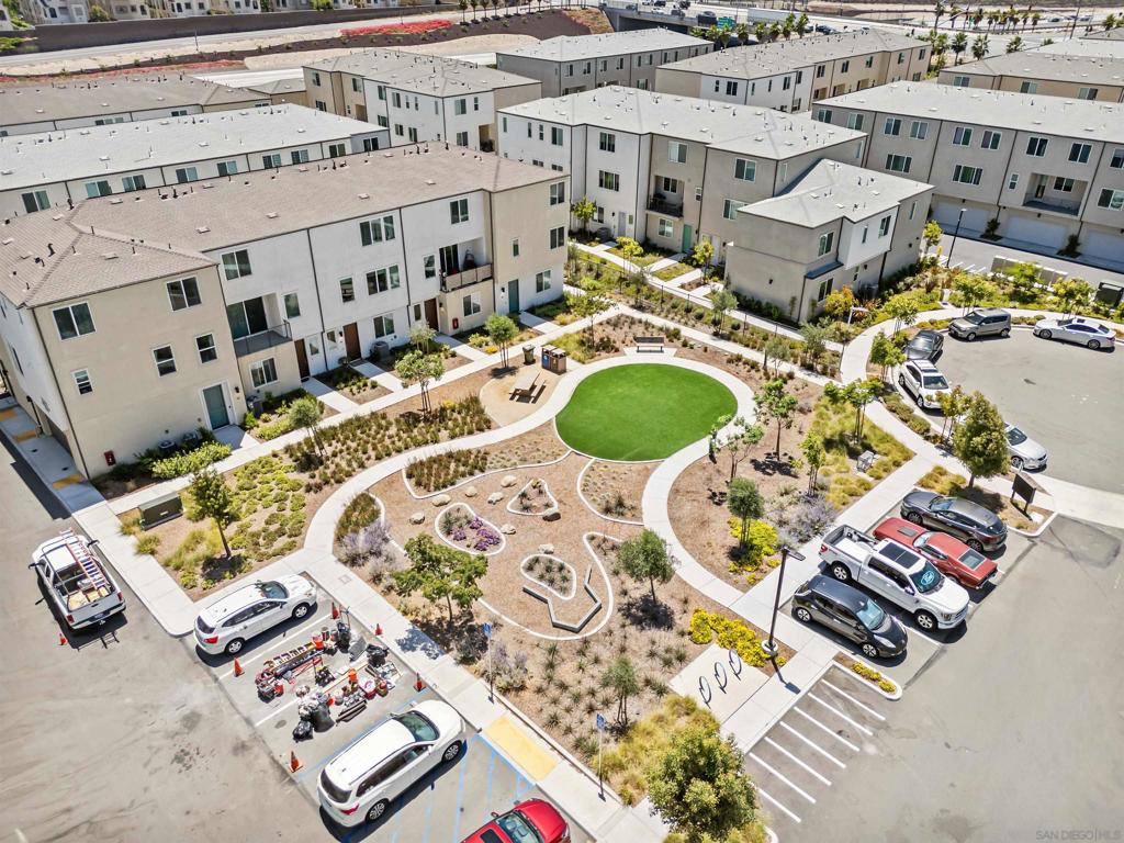 Want a San Diego home with past years interest rates? Here’s your chance: this property comes with an Assumable VA Loan at 5.4%! Plus, the seller will cover one full year of HOA fees for the buyer. Built in 2022, this tri-level corner townhome blends modern design, comfort, and efficiency. Featuring 2 bedrooms, 2.5 bathrooms, and a fully paid solar system (say goodbye to electric bills), the home is turn-key ready. The first level offers an attached two-car garage. The main floor boasts an open-concept living space with luxury laminate floors, quartz countertops, stainless steel appliances, and a custom island. Recessed lighting and oversized windows fill the space with natural light, while a powder room adds convenience for guests. Upstairs, you’ll find two ensuite bedrooms. The primary retreat includes a spa-inspired bath with dual sinks, a walk-in shower, and a generous walk-in closet. The secondary bedroom features its own full bath with a tub/shower combo, perfect for family or guests. Located just minutes from the freeway, Naval Base, beaches, Sesame Place, schools, and major shopping, this home offers easy access to it all. With a low HOA of $230/month covering beautifully maintained green spaces and picnic areas, it’s the best of modern, low-maintenance San Diego living.