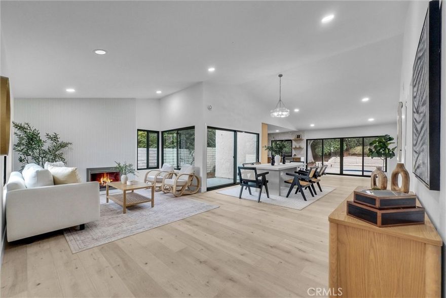 Discover this meticulously remodeled 4-bedroom, 2-bathroom residence situated on Avenida Rio Del Oro in Yorba Linda's sought-after neighborhood. This 1,838 square foot home showcases an open floor plan that seamlessly connects living spaces, creating an ideal environment for both daily living and entertaining.



The spacious living room centers around a welcoming fireplace, flowing into a generous dining area and gourmet kitchen. The kitchen features stainless steel appliances, including a commercial-style gas range and drawer microwave, complemented by light oak shaker cabinetry, quartz countertops, and porcelain tile backsplash. Light oak plank laminate flooring and recessed lighting enhance the modern aesthetic throughout.



The primary bedroom includes a walk-in closet and an updated bathroom with porcelain and quartz tiled shower surround, dual shower heads, frameless glass doors, quartz flooring, and dual sinks. Three additional bedrooms feature mirrored wardrobe doors and matching laminate flooring. The hall bathroom offers porcelain tile around the tub, dual sinks, and quartz flooring.



Modern conveniences include central air and heat, plus a two-car garage with rollup door. The backyard features a refinished swimming pool surrounded by mature landscaping, perfect for California outdoor living.



Located within walking distance of Yorba Linda High School and close to Vons for convenient shopping. The property offers easy access to parks and public transportation, positioning residents in one of Orange County's most desirable communities. This turnkey home combines contemporary updates with practical functionality in a prime location.