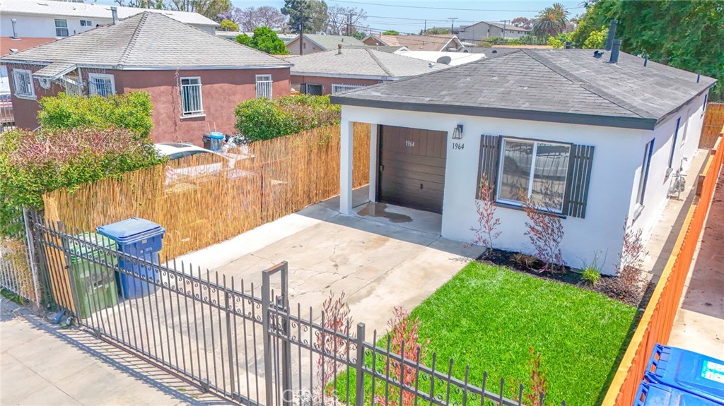 Perfect Starter Home. Move in ready... Features include: 2 Bedrooms / 2 Bathrooms + Partially Converted Garage with a Kitchenette, Beautiful kitchen with granite counter tops, updated bathrooms, Tile flooring in Living room, Kitchen, and Baths, New Carpet in Bedrooms. Uncovered driveway parking. Alarm on property, Freshly painted interior and exterior. This is a must see!