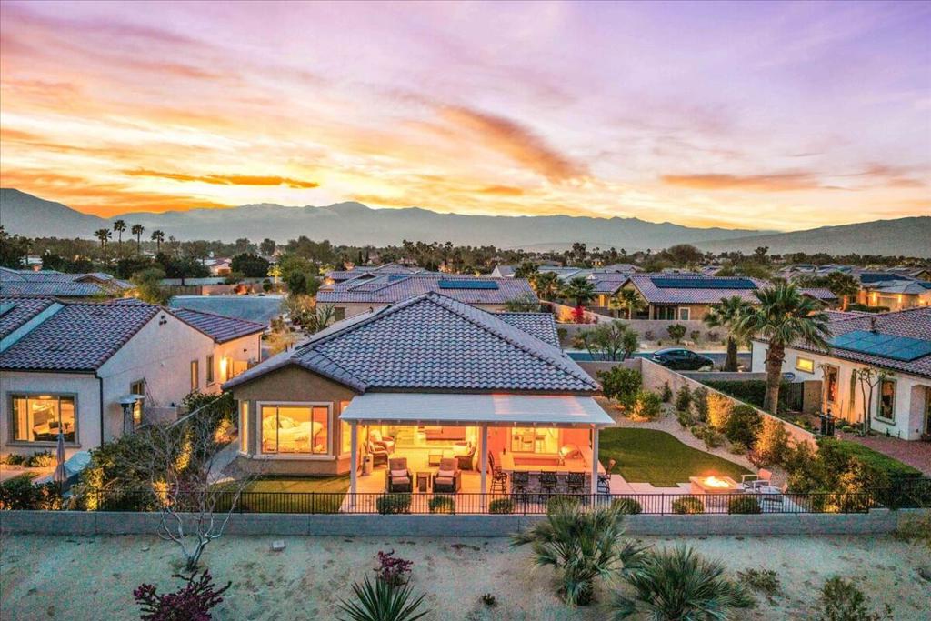Discover Del Webb at Rancho Mirage for 55+ active adult resort-style living! Popular REFUGE model on oversized view lot. IDEAL phase one location. Enjoy scenic mountain views & open vistas. Welcoming circular foyer leads to guest wing + den (or 3rd bedroom) complete with custom desk built-ins, closet with cabinetry--all behind hanging double barn doors. Soaring ceilings & custom stacking glass sliders let in natural light. Home designed for entertaining & relaxation--spacious great room features built-in media center with display niches and upgraded corner wet bar PLUS powder room. Gourmet kitchen with upgraded oversized island/breakfast bar--this kitchen has ALL the desired EXTRAS! Fresh, white cabinetry; roll-outs; wall oven microwave combo; gas cooktop; double sink; granite & quartz counters; decorative tile backsplash; walk-in pantry. Adjacent dining area also opens to backyard. Open sliders to reveal an outdoor paradise. Custom outdoor kitchen/BBQ bar--PLUS firepit lounge area! Large, covered patio even has video pre-wiring. Landscape designed to showcase views and give a lush feel with faux turf and mature easy-care plantings. Primary suite with bay window and spa-like walk-in dual-head shower! Large walk-in closet. Over $200k in builder & custom upgrades--must see to appreciate finer details. Custom upgrade list available upon request. Plank-vinyl flooring & carpet; motorized shade blinds; expanded laundry w/utility sink; 15-panel OWNED Solar. Mini-split A/C in oversized garage (space for golf cart) & overhead rack storage. Entertain, enjoy gorgeous interior, lounge outdoors, stargaze--this resort-like property is the IDEAL place to call HOME! Guard-gated community offers: clubhouse, pools & spa, tennis, pickleball, bocce, fitness, putting green, miles of meandering pathways & MORE. Stop searching & START living!