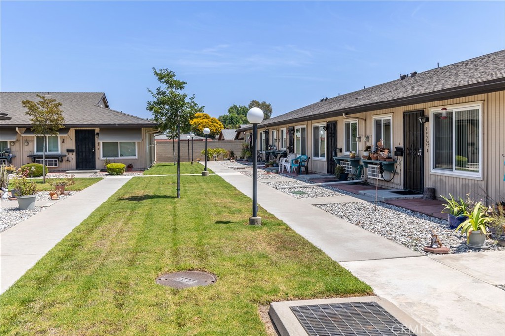 Welcome to 9924 Cedar St in Bellflower, a beautifully updated single-level townhome situated in the highly desirable and rarely available section of the gated Bethel Manor 55+ community. Tucked fully behind the gates with no direct street access, this home offers an extra sense of privacy and security that sets it apart. Featuring two bedrooms, a full bathroom, and an open, light-filled layout, the living and dining areas flow seamlessly into the kitchen, creating a comfortable and inviting atmosphere. Recent upgrades include brand-new carpet and baseboards, freshly painted interiors, and scraped ceilings for a clean, modern look. The secondary bedroom opens onto a private covered patio perfect for morning coffee or evening relaxation. Additional conveniences include in-unit laundry with washer and dryer and an assigned covered carport with storage. Manicured greenbelts create a serene, park-like setting throughout the neighborhood. Residents of Bethel Manor enjoy low HOA dues that cover water, trash, gated access, and a clubhouse with a full kitchen, fireplace, shuffleboard, and well-maintained grounds. With its rare and secure location, 9924 Cedar St offers the ideal blend of comfort, convenience, and peace of mind in a welcoming senior community.. These units within the gates rarely go on the market and are highly sought after, so don't miss this opportunity.