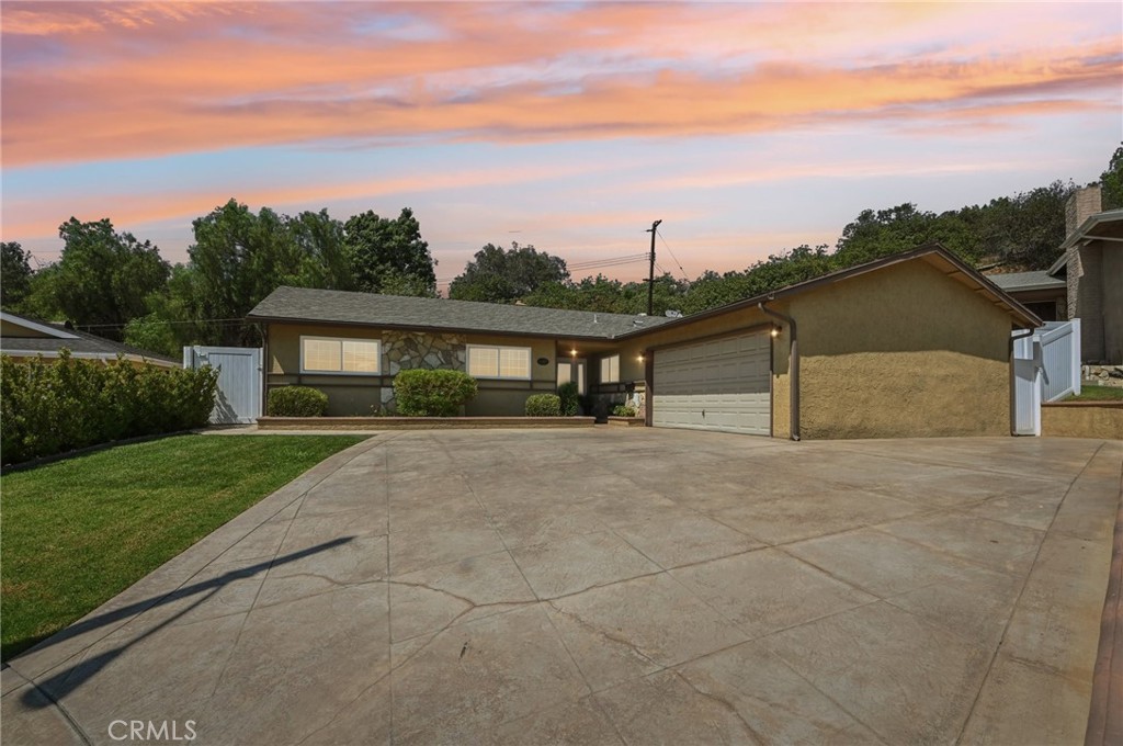 Welcome to your dream home nestled in a peaceful cul-de-sac neighborhood of Glendora! This turn-key four-bedroom, two-bathroom residence is meticulously maintained and move-in ready. Upgraded front driveway with stamped concrete and beautiful front door. Extra side concrete perfect for additional car. Step inside discover an upgraded kitchen that seamlessly blends style and functionality, featuring modern appliances, Corian countertops, pendant lighting, and ample size kitchen nook. The bathrooms have been tastefully renovated, offering a fresh and contemporary feel. You'll love the spacious bedrooms, with closet organizers for maximum storage efficiency. Recessed lighting enhances the warm ambiance, and the new flooring with upgraded baseboards adds a touch of elegance to every room. Dual pane windows. Newer Air Conditioner. Situated on an ample-sized lot, this property provides plenty of outdoor space for entertaining or relaxing. Enjoy the convenience of being just minutes away from downtown Los Angeles, with easy access to freeways, reputable schools, and shopping. The home is a perfect blend of comfort and convenience, ideal for families seeking a welcoming community. Don't miss this exceptional opportunity! Be home for the holidays!