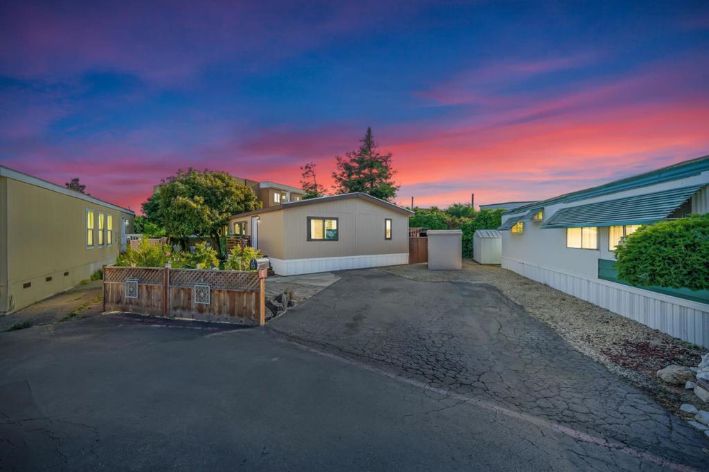 Mobile homes like this do not come around everyday. The current sellers have lived here 35 years and have taken great care of this home and pride of ownership is everywhere you look! Located on a lot with an extra long driveway. There are yard areas all around house, which include a covered gated area, a vegetable garden and the following trees: Redwood, Avocado (produces approximately 200 avocados per year), Spanish Olive, Artichoke, Peach, & Pear Tree. The front entry door has been replaced; vaulted ceiling to give more space; living room carpet replaced approximately 2 years ago. The kitchen has new flooring & new countertop. All appliances convey with the home. Bathroom toilets have been replaced. Primary bedroom has a large walk-in closet. Fresh paint and new light fixture in the primary ensuite bathroom. Repiping was completed approximately 15 years ago. The mobile home sits on a corner lot, has no backyard neighbor, and is in a well-maintained community that has easy access to local schools, shopping, entertainment, and HWY 101 for an easy commute!