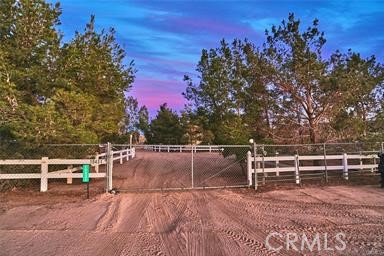Beautiful Ranch Style Home with all of the extras, SOLAR , PRIVATE WATER WELL and 9 Horse stalls/Barn with automatic water feeders , Plenty of room to add more stalls, Income producing, Tack Room/Wash Station /Round Pen/HUGE Riding Arena. Truly a horse lovers paradise with Chicken Coop/Garden Area & Fruit Trees, Over Sized Detached Garage W/ bathroom. Surrounded by Mature Trees on almost 3 Acres of Fenced Land with VIEWS Of the City, Mountains & Desert Enjoy your Favorite Cocktail or Coffee from the Upstairs Balcony OR from the back yards patio, 2 bedroom's downstairs w/ Main bathroom and Master Suite is Upstairs Kitchen has Large Picture Windows over looking the amazing yard Center Island Must see to appreciate.