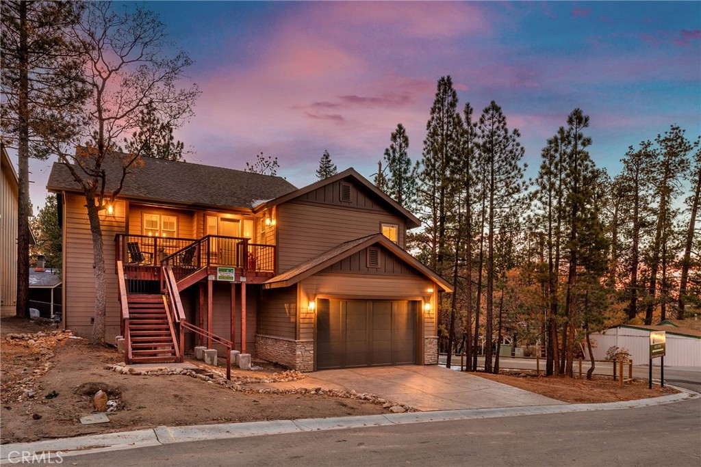 A MUST SEE! Discover the epitome of custom-modern finishes and meticulous design to this newer construction, 4 bedroom, 3 1/2 bath Big Bear Lake Home at THE PINES. Nestled within walking distance to "The Village" and National Forest area this stunning mountain-lake retreat boasts a Gourmet Chef's Kitchen, DACOR appliances, Nest Smart controlled Thermostat and SONOS Home Entertainment Theater systems for a luxury experience and entertainer's dream. Canterbury Elm Plank flooring throughout, leads you through this large "light and bright", open concept floor plan with vaulted ceilings, highlighted by a contemporary, tile finished, gas fireplace. Beautiful, elevated balcony with Hot Springs Hot Tub and BBQ culminate the endless enjoyment to be had at this one of a kind home. The second floor also features 2 spacious Master Bedrooms with ensuite bathrooms and separate laundry room. Downstairs (1st floor) you will find two spacious bedrooms, perfect for additional guests, large family accommodations, two-car garage with EV CHARGING and plenty of storage area for all your year round mountain and lake activities. This unique residence has served as a special family getaway for winter, summer and all-year round enjoyment, as well as generating significant short-term rental income (see supplemental) for the savvy new owner. Come discover the essence of luxury Big Bear Lake living.