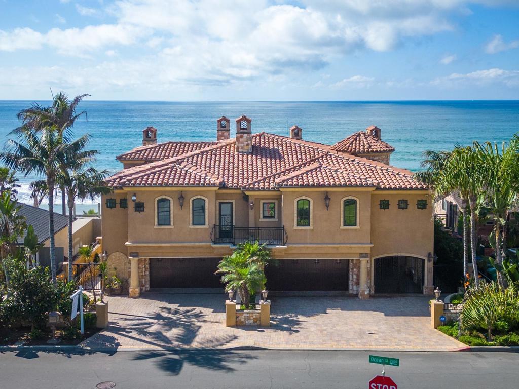Exceptional oceanfront home offering unobstructed breathtaking ocean views up to Dana Point with private beach access for the ultimate coastal living experience. Located within walking distance to a variety of restaurants, shops, and entertainment options, this home is perfectly situated steps from the Carlsbad Village. Immerse yourself in the vibrant atmosphere and enjoy the convenience of having everything you need right at your fingertips. Step inside and be captivated by the exceptional quality of construction and attention to detail. The open floor plan is designed to maximize the stunning ocean view, with nearly every room in the home offering a glimpse of the sparkling blue waters. The main level features a spacious primary suite... complete with a spa bath featuring a jetted tub and a walk-in closet. Imagine waking up to the sound of crashing waves and stepping out onto your private balcony to enjoy a cup of coffee while taking in the panoramic ocean vistas. Downstairs, you'll find the secondary bedrooms, each with their own en-suite bathrooms for added privacy and convenience. The family room provides a cozy space for relaxation and entertainment, perfect for movie nights or spending quality time with loved ones. This home is not only aesthetically pleasing but also thoughtfully designed for practicality. The huge walk-in wine storage room ensures you have ample space for your collection, while the two-car garage and additional storage areas provide plenty of room for your paddle boards, electric bikes, and all your beach toys. The attention to detail extends beyond the inte