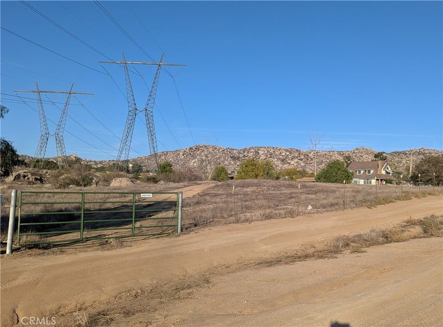 5.05 Acre on a dirt road, zoned R-A-1.  Area is Romoland, but the home next door has a Menifee address.  There are 2 Edison Power Towers running through the property with high voltage power lines.  There is some buildable area at the front right of the property.  Property has some large rocks.    There are homes on each side of lot... addresses are 29696 & 29720 Mountain Ave.  Affordable lot for someone wanting a large lot, but only wanting to maintain a smaller area.  Fun property for exploring and nice natural landscaping. Septic, & Propane area.  Electric at the street. EMWD water at neighbor home.