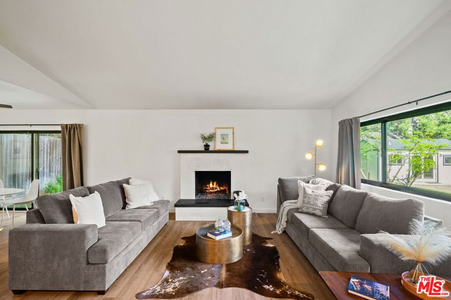 A rare property in Old Topanga with a second entrance from the quiet Bonnell Drive. This beautifully remodeled view filled three-bedroom, two bath home offers modern amenities, unexpected upgrades, and one of the largest flat lots in the area. You'll appreciate the expansive, usable yard rarely found in Topanga.The home features a stylish kitchen with classic white shaker cabinets, sleek quartz countertops and stainless appliances. You'll love cooking and entertaining in this beautiful space, which opens up to a lovely outdoor patio where you can soak in the peaceful ambiance of your surroundings. Kitchen accesses a full laundry room with storage, utility sink and a side entrance to outdoors. The main level includes one bedroom and full bath, while two additional bedrooms and a full bath are located upstairs, with access to the second story deck. The spacious living room has vaulted ceilings, recessed lighting, and a striking  fireplace, creating a bright and inviting atmosphere for entertaining or relaxing. Upgraded privacy-maintaining windows fill the space with natural light while ensuring a peaceful indoor retreat and blocking the UV rays. The real magic of this property lies outside, where you'll find a sprawling, beautifully landscaped yard with plenty of space for outdoor activities and entertaining, while being completely fenced. In the rear of the yard is a detached studio guesthouse, complete with a 3/4 bath and  patio. Outdoors offers one of the largest, flattest yards in Topanga Canyon, with a large patio area, easy care turf.  A wooden bridge crosses over the seasonal creek leading to another sunny yard perfect for those wanting to have a veggie garden. The second entrance on Bonnell Drive has an automatic gate and room to park an RV or extra cars. Additional highlights include a two-car garage equipped with an EV charger, Ring doorbells at the front entrance and garage.A rare find in Topanga, this property combines flat usable land, upgraded finishes, and quiet privacy It's a short distance to Bonnell Park, Red Rock Park and the Skyline Loop. Improvements completed in 2023 and 2024 include roof, windows, HVAC, kitchen and bath remodel, flooring, paint,  plumbing, electric, detached guest house/office and automatic gate on Bonnell. Both full baths have also been remodeled in the same style as the kitchen. All flooring has been redone, with warm toned high-quality engineered wood and carpets. Renter's insurance required.