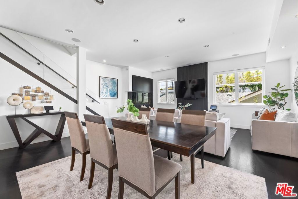 Just steps from the sand, this fully remodeled town home in the heart of Marina Del Rey offers the ultimate blend of coastal living and modern design. With soaring ceilings, wide-plank wood floors, and floor-to-ceiling windows, the space feels airy and bright from the moment you enter. The main living area centers around a dramatic 250-gallon saltwater aquarium and a sleek fireplace, creating a striking focal point. The chef's kitchen is outfitted with high-end stainless steel appliances, custom cabinetry, and a stunning waterfall island perfect for entertaining. Two spacious bedrooms include spa-like en-suite bathrooms, while the upstairs loft with its own kitchenette offers flexibility as a home office, guest suite, gym, or creative space. The private rooftop deck is a true showstopper, with sweeping ocean, mountain, and city views ideal for relaxing, entertaining, or catching nightly sunsets. Other features include smart-home integration, a second fireplace in the primary suite, and two-car garage parking. All of this just moments from Venice, Abbot Kinney, and the best of Silicon Beach. Rarely does a property of this caliber, style, and location become available an exceptional opportunity in one of LA's most sought-after coastal enclaves.